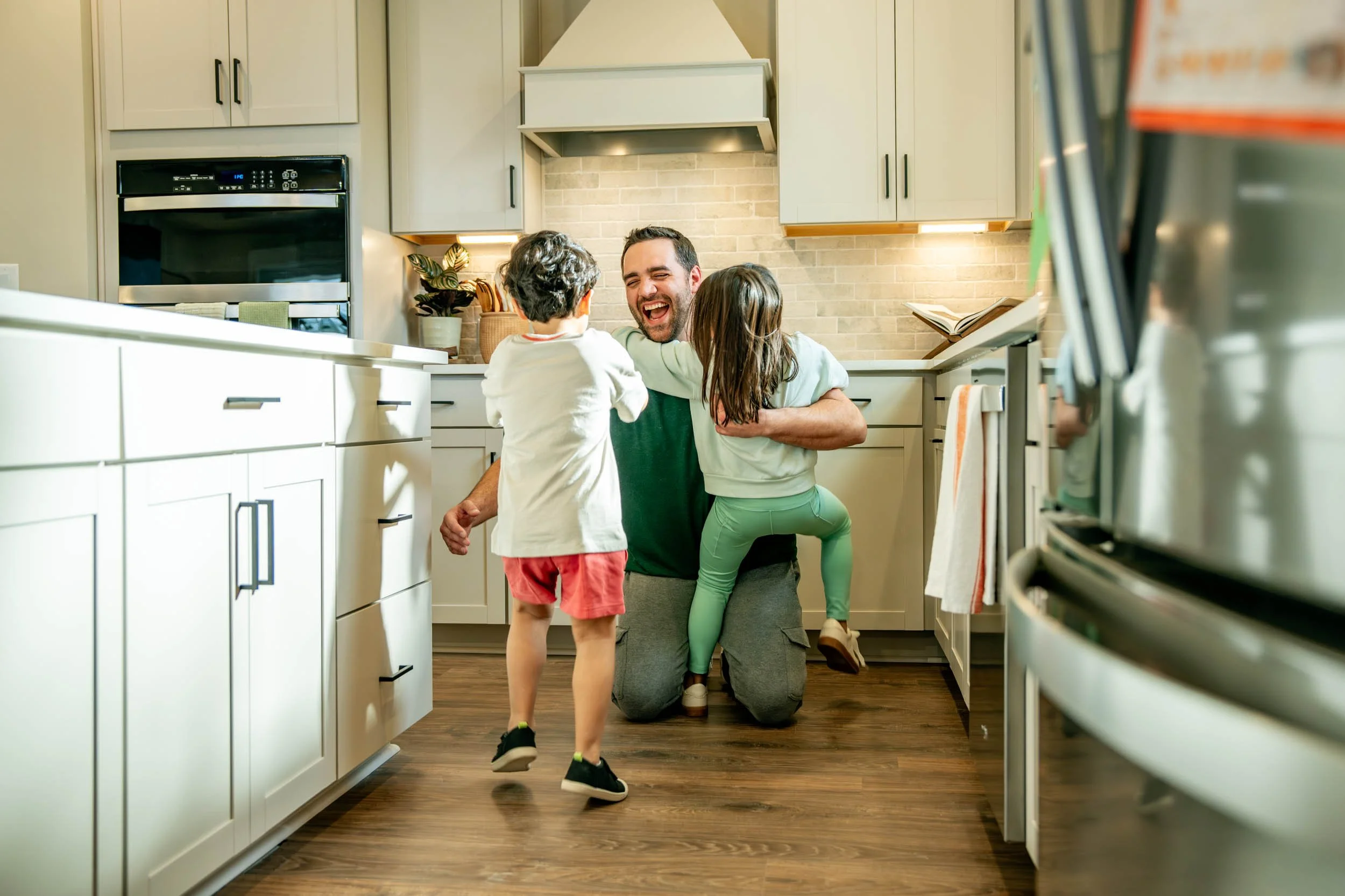 Dad-Hugging-Kids-in-Kitchen.jpg