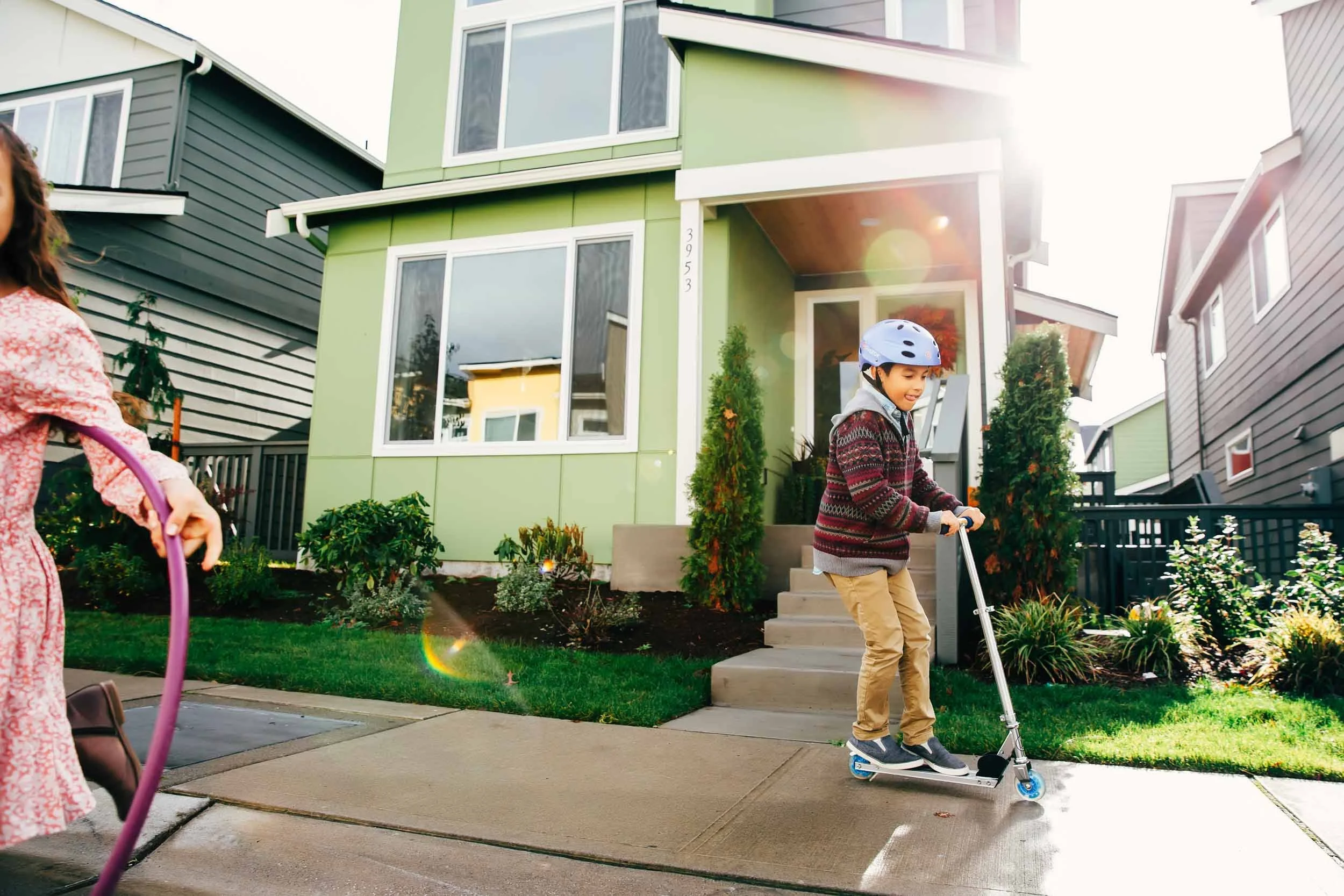Boy-on-scooter-in-front-of-house.jpg