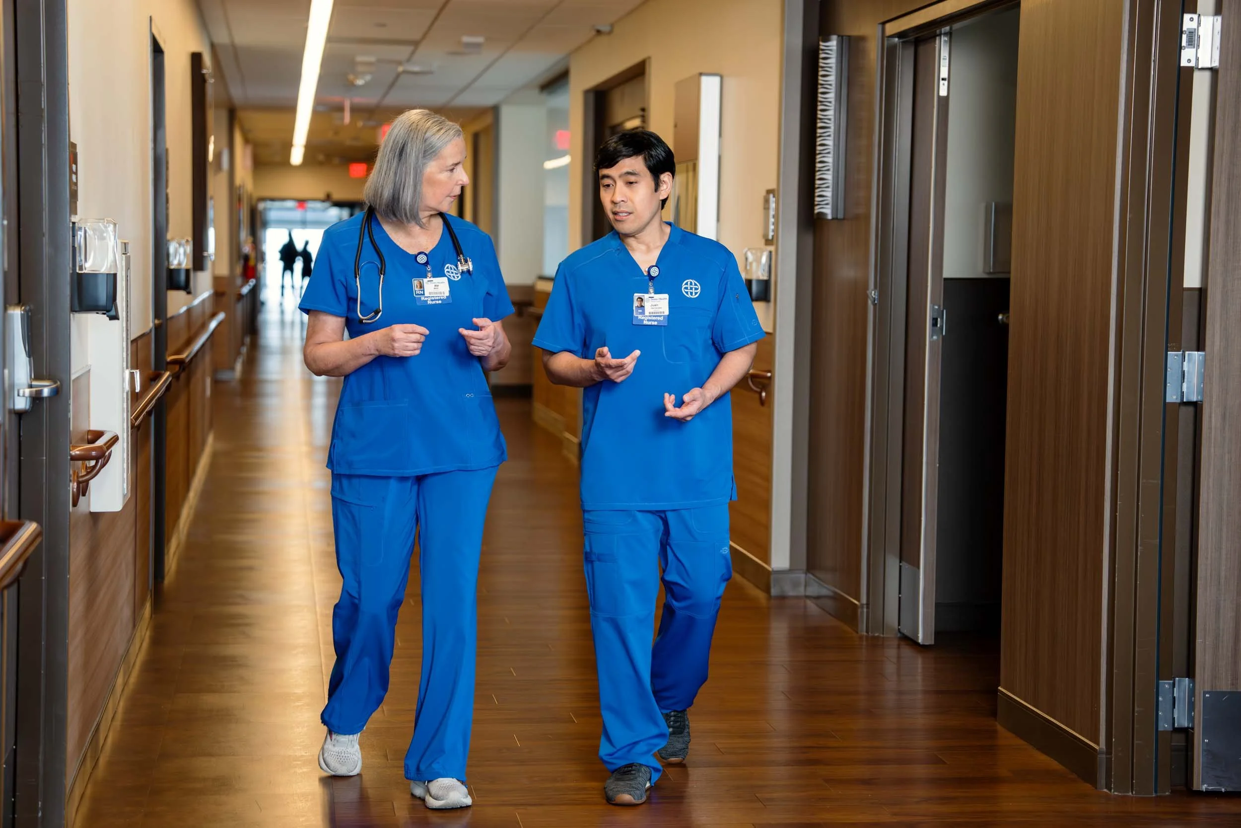 Nurses-Walking-in-Hospital-Corridor-Talking.jpg