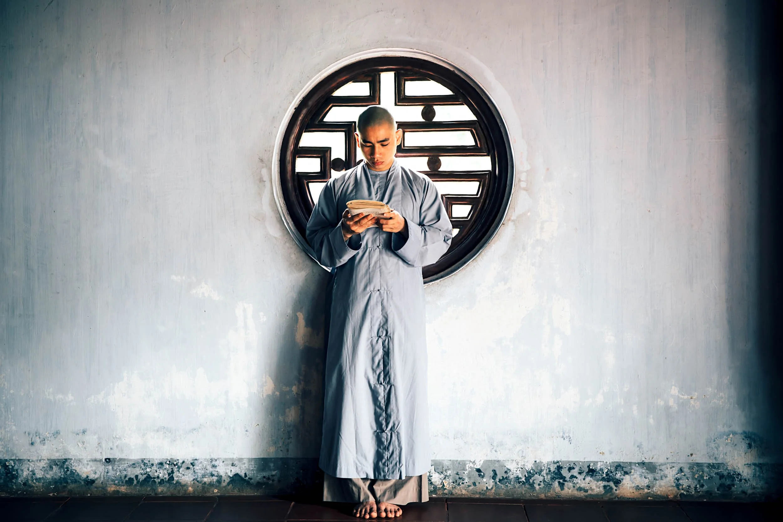 Buddhist Monk-Reading-by-Circular-Window.jpg