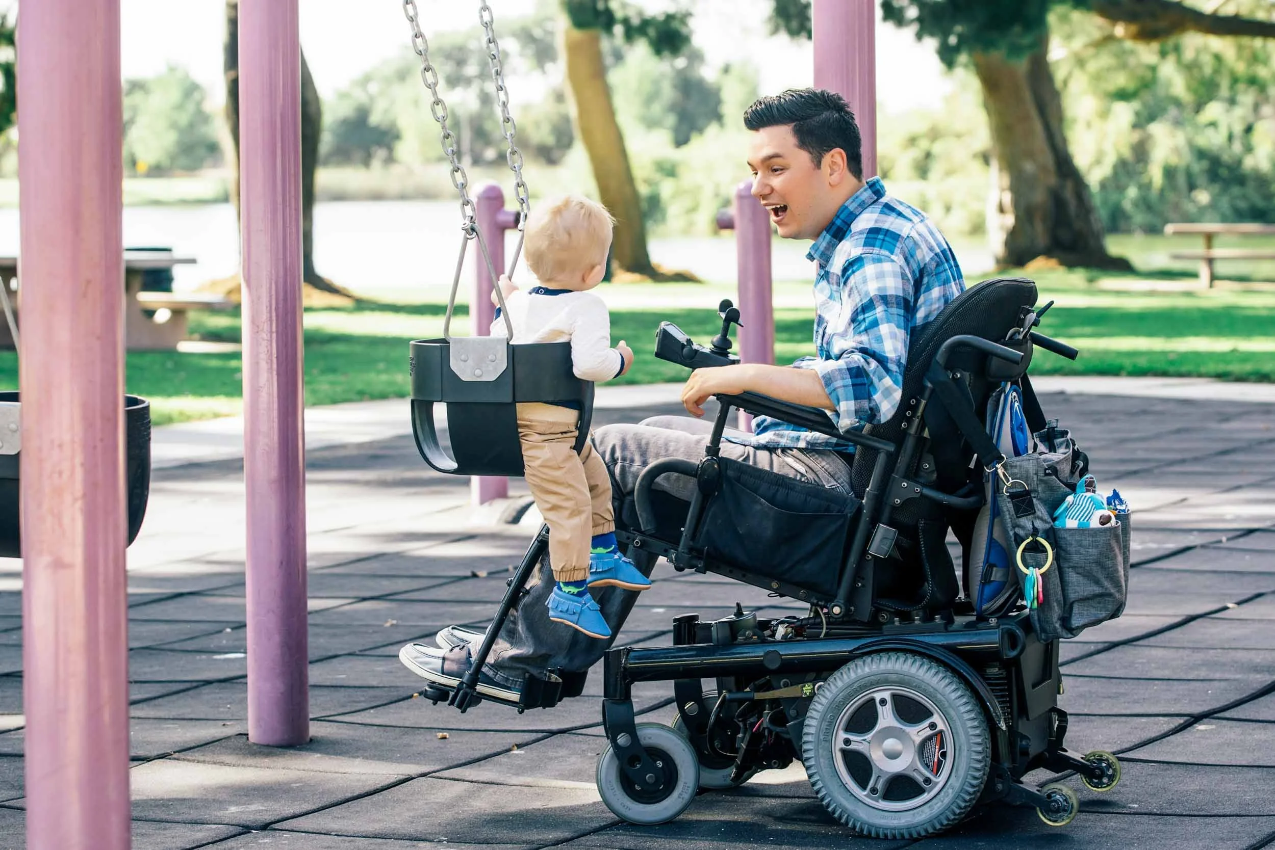 Parapalegic-Pushing-Baby-on-Swing-in-Park.jpg