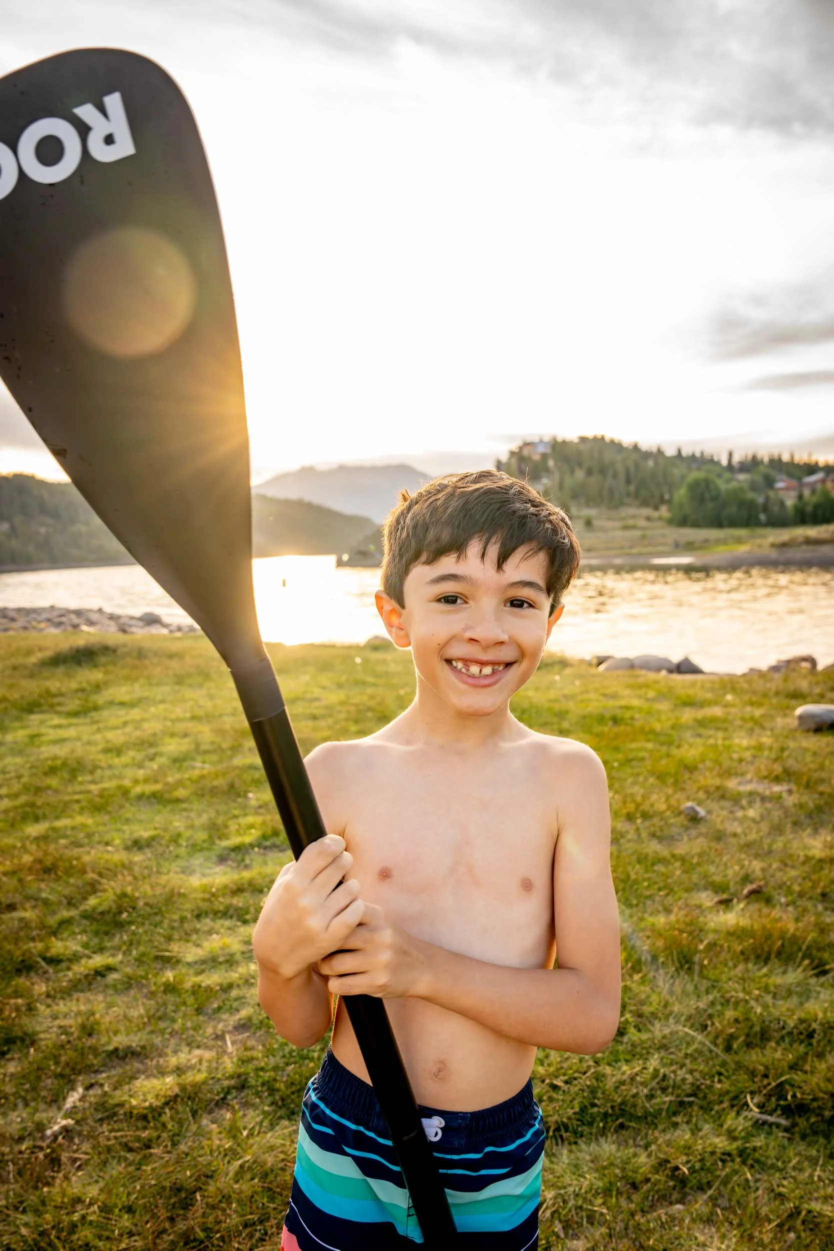 Smiling-Boy-with-Paddle-by-Water.jpg