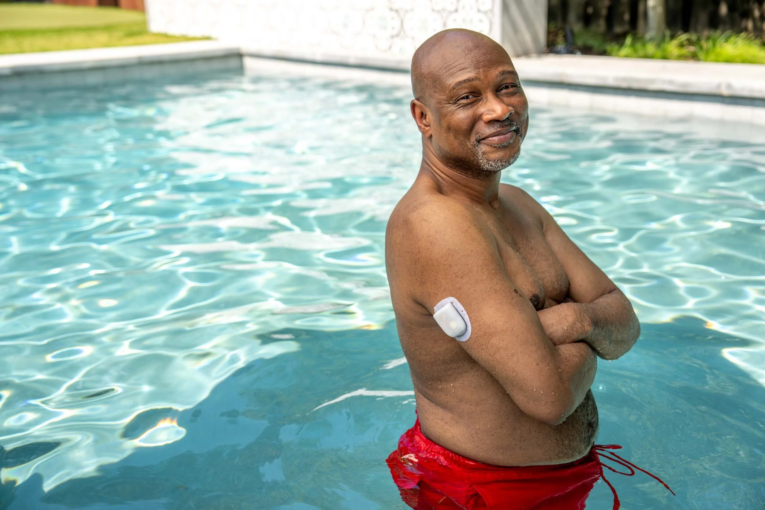Man-in-Pool-with-Glucose-Monitor-Device.jpg
