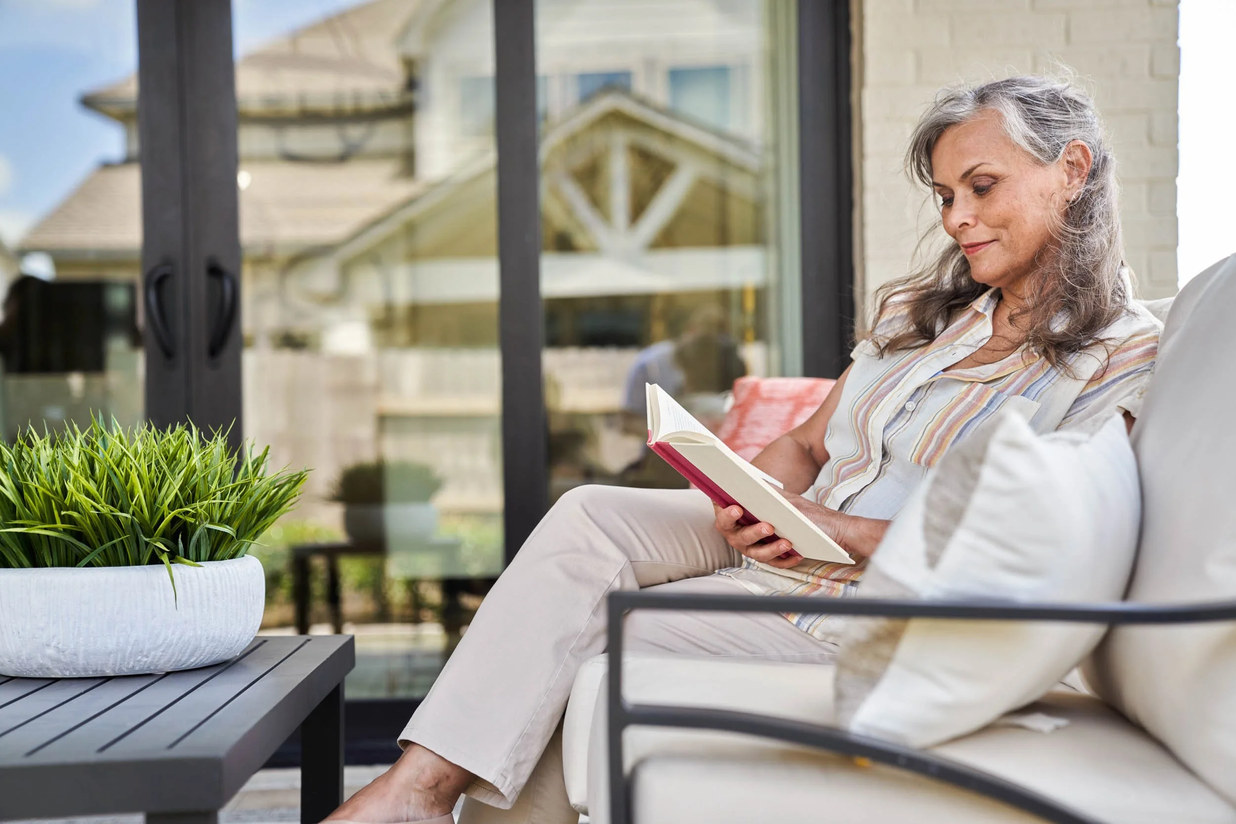 Woman-Reading-Book-on-Patio.jpg