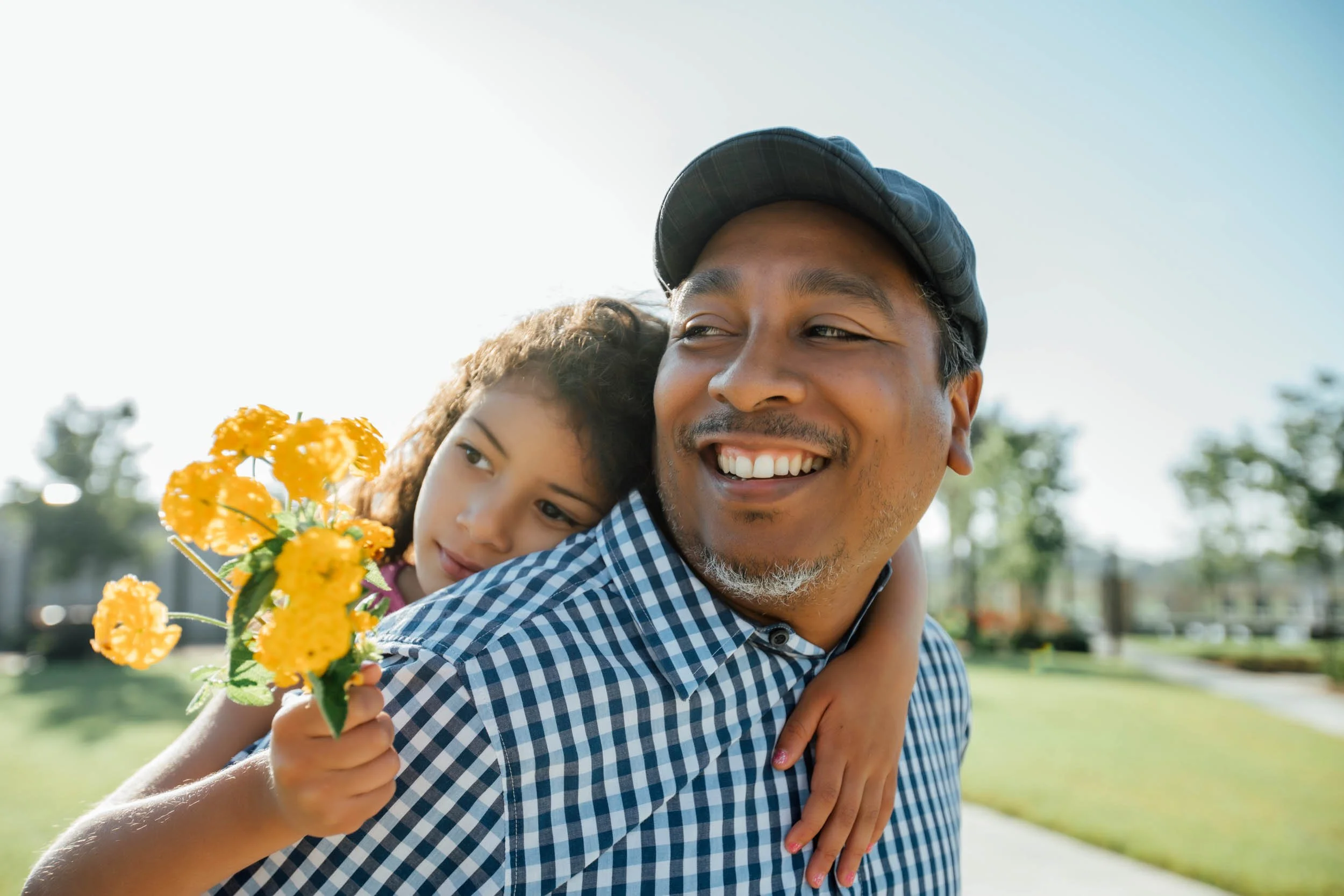 Father-Carrying-Daughter-Outdoors.jpg