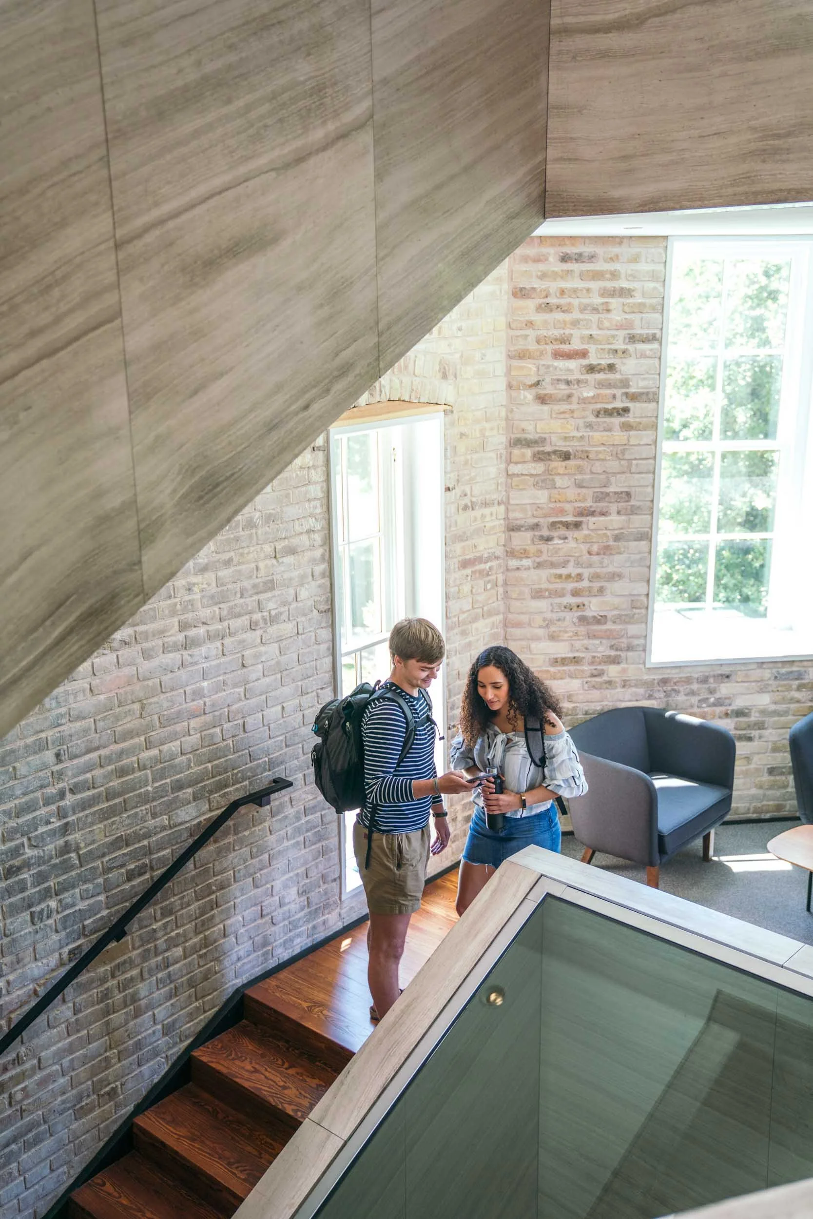 Students-in-Stairwell-on-Campus-Looking-at-Phone.jpg