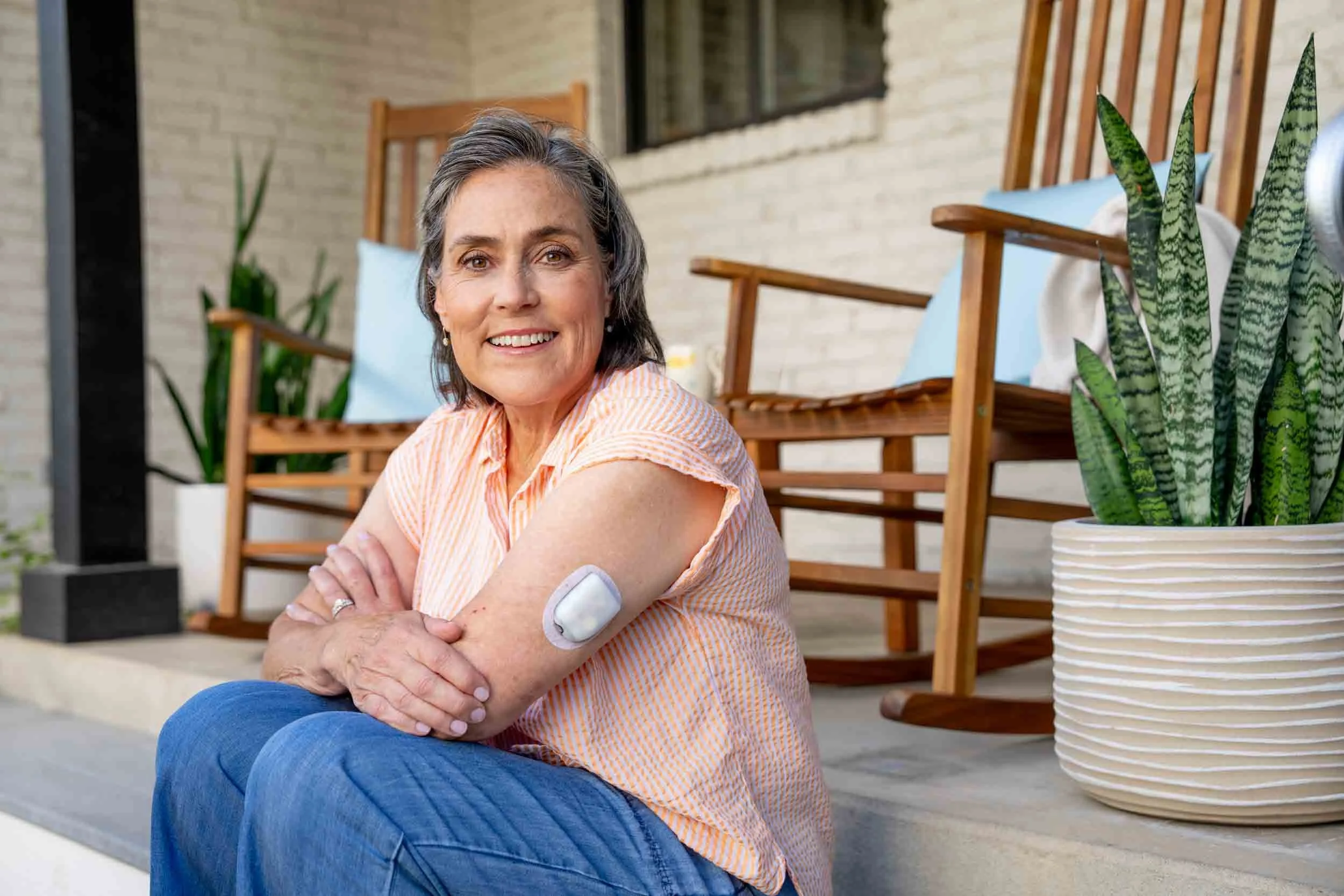 Woman-on-Porch-with-Glucose-Monitoring-Device-on-Arm.jpg