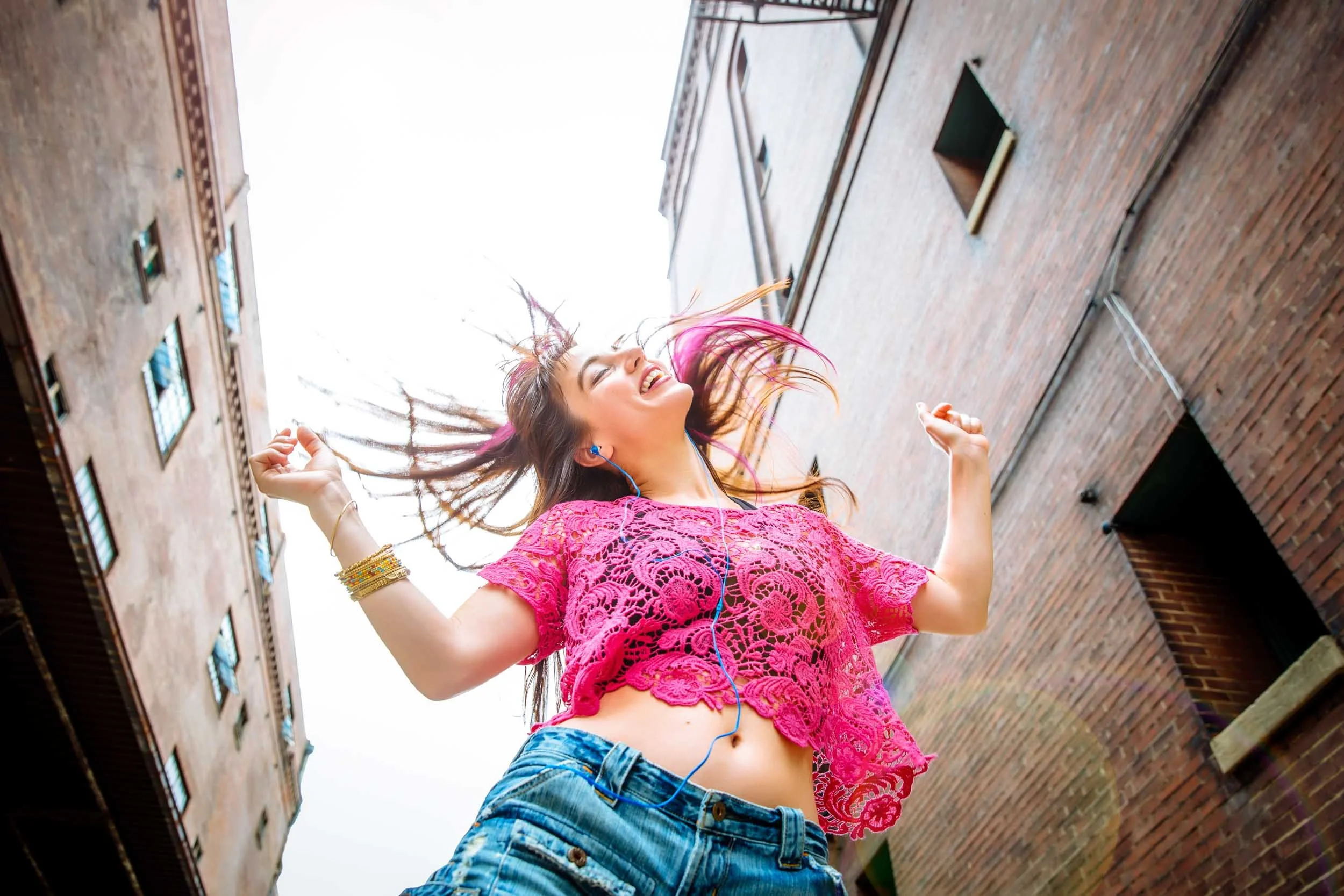 Woman-Joyfully-Dancing-in-Urban-Alley.jpg
