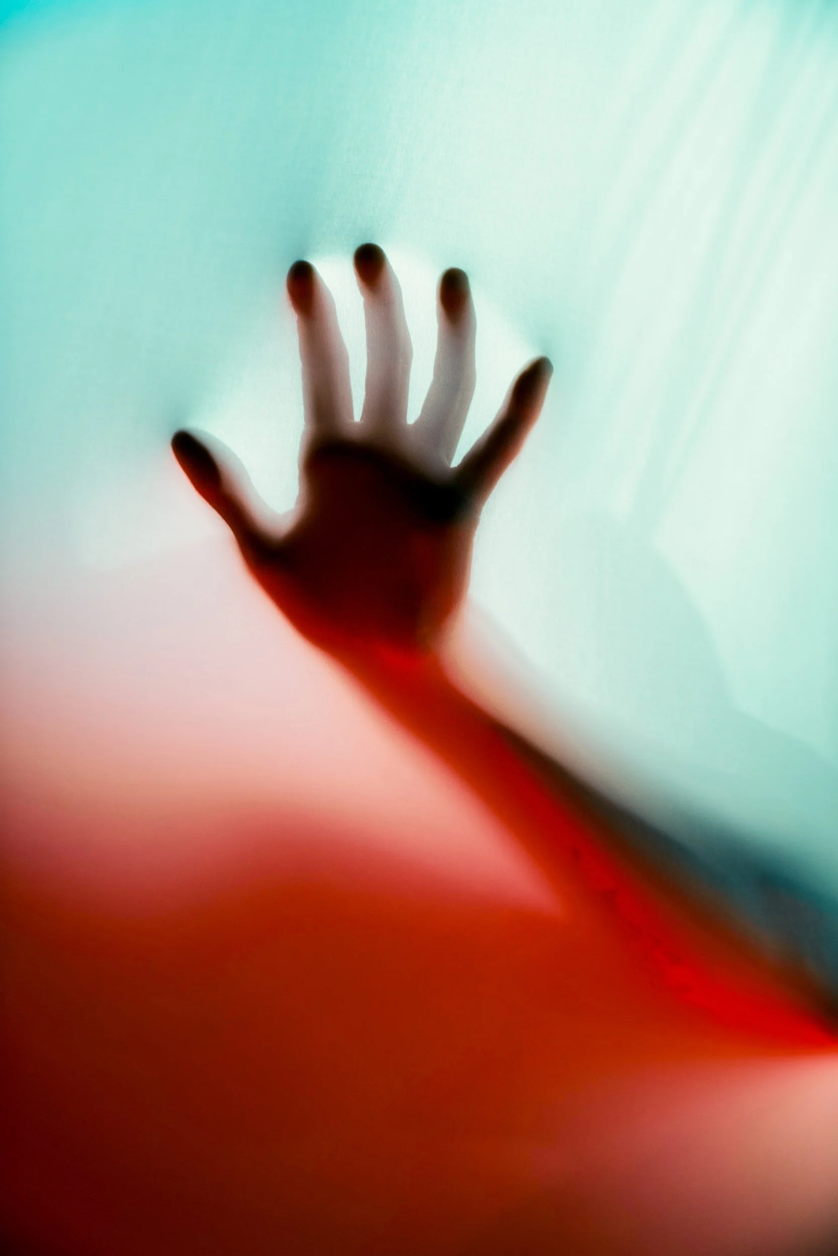 Silhouetted-Hand-Pressed-Against-Surface.jpg