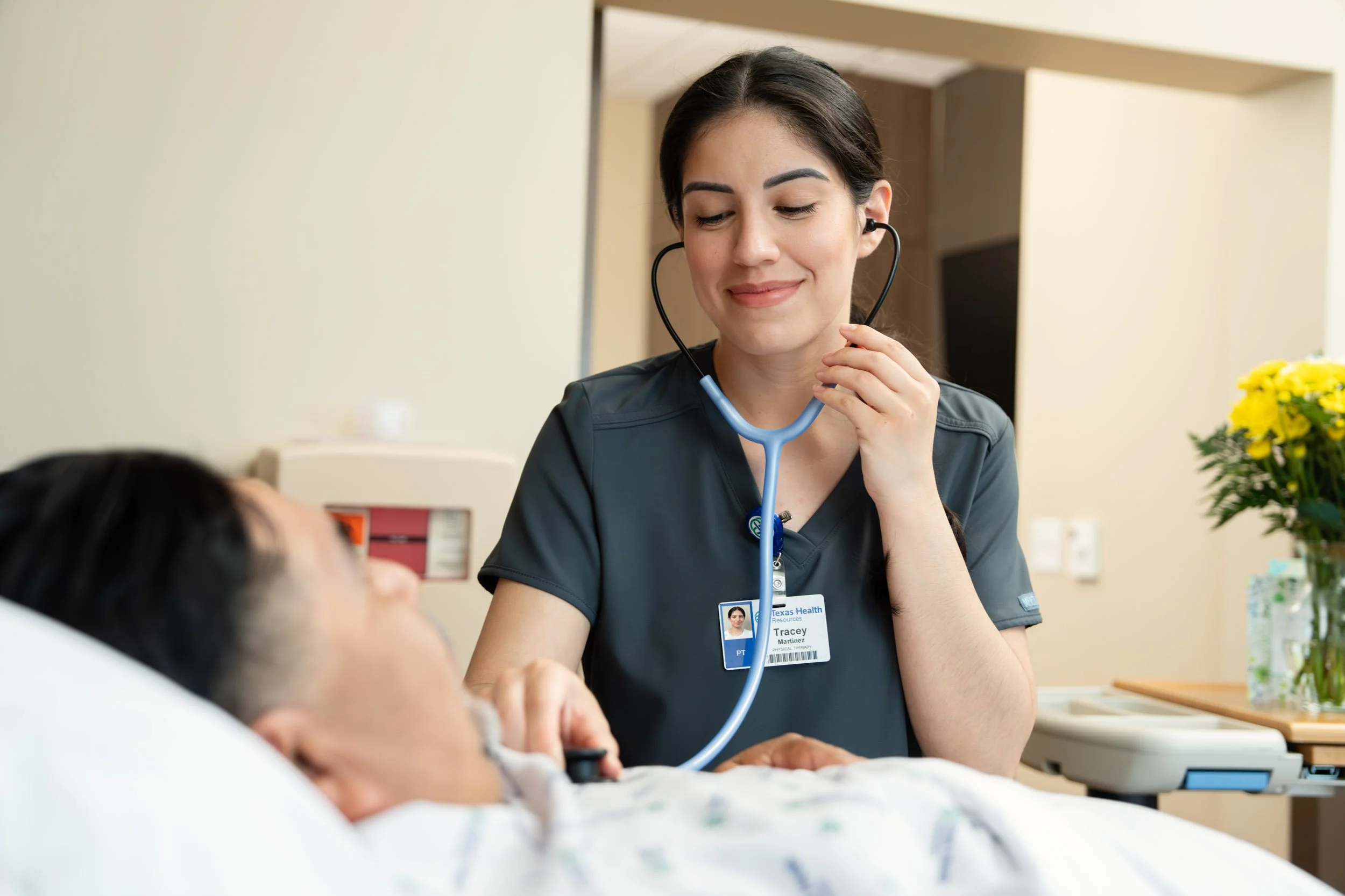 Nurse-Using-Stethoscope-on-Patient-in-Hospital-Bed.jpg
