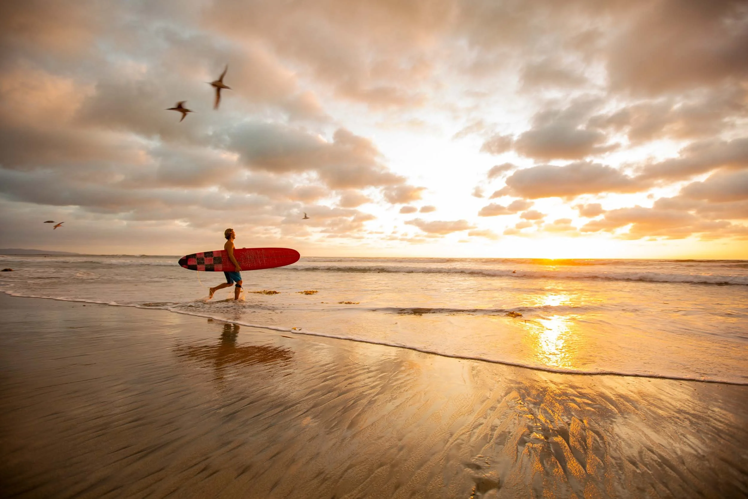 Surfer-at-Sunset-on-Beach.jpg