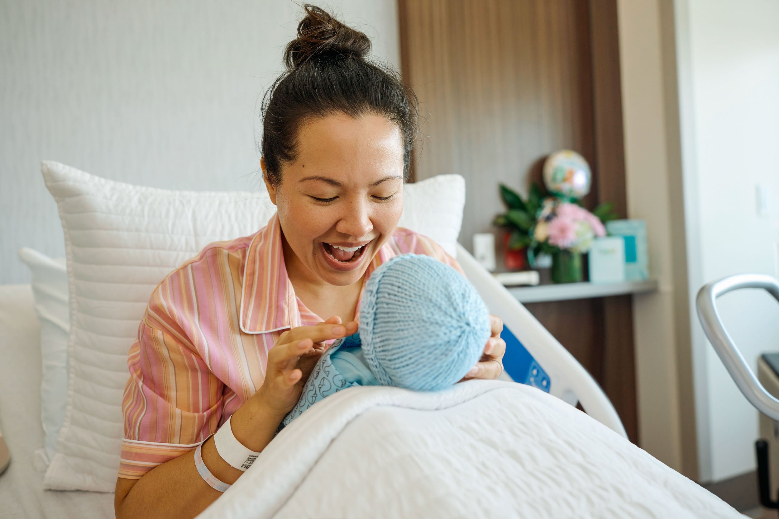 Excited-Mom-with-Newborn-in-Hospital.jpg