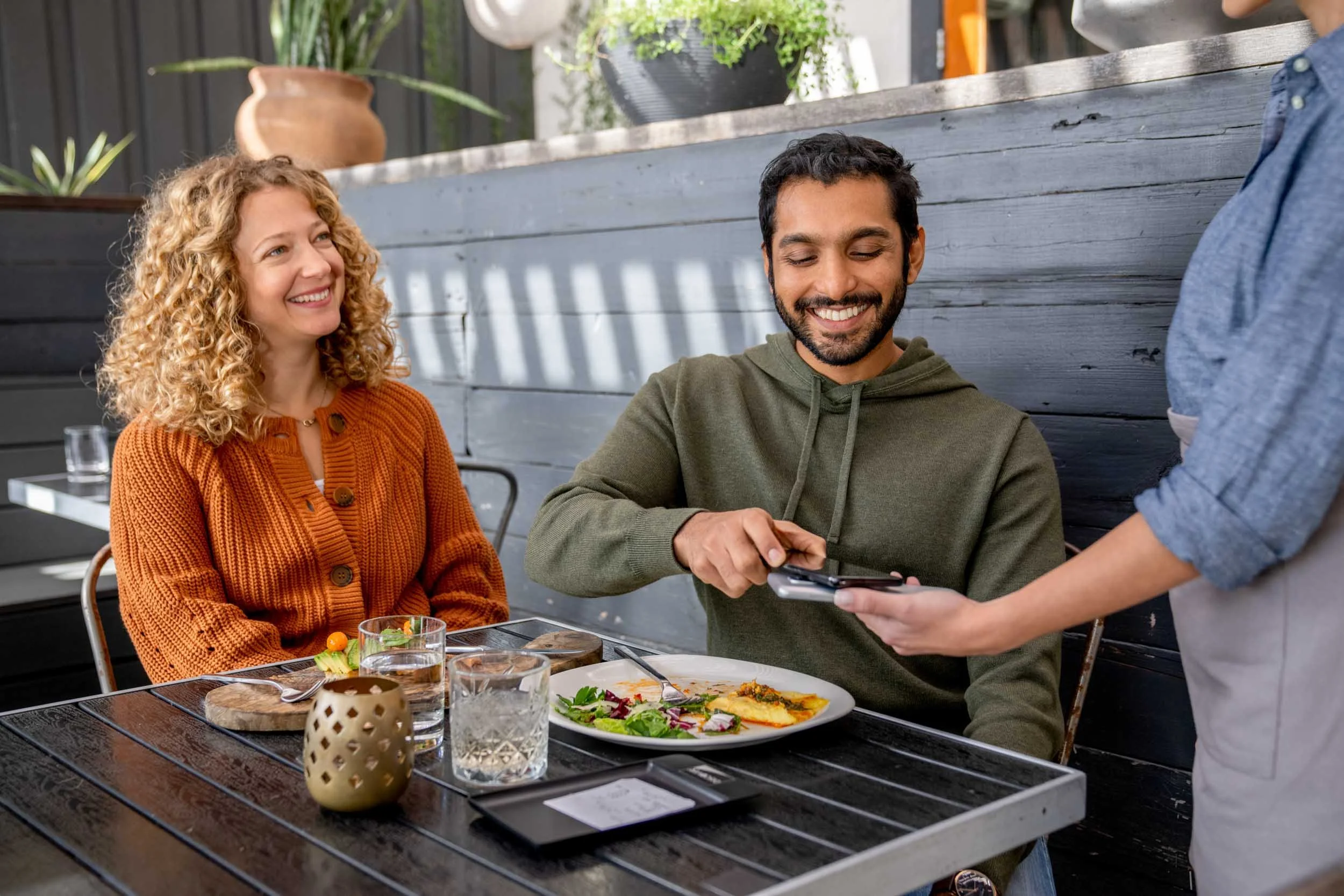 Man-Using-Phone-to-Pay-in-Restaurant.jpg