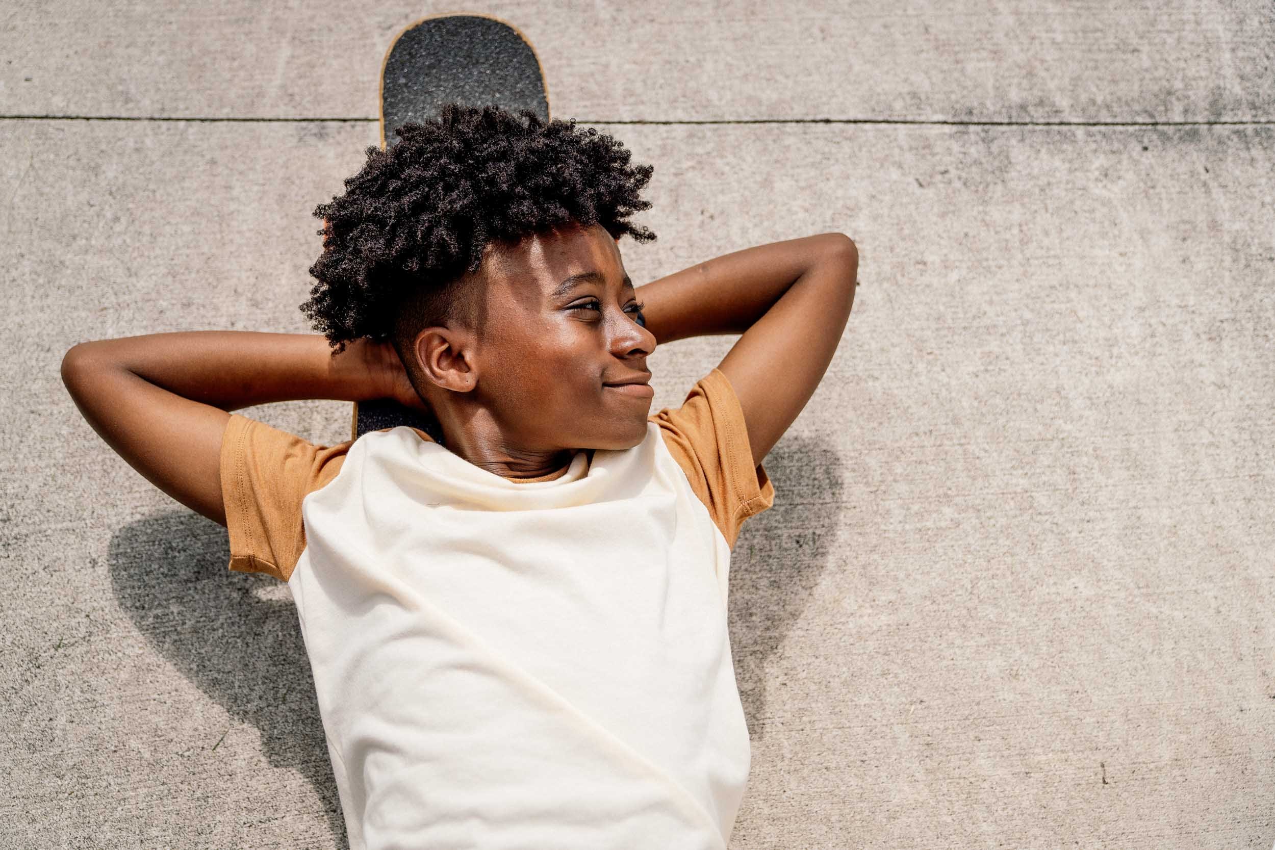 Tween-Boy-Relaxing-on-Skateboard.jpg