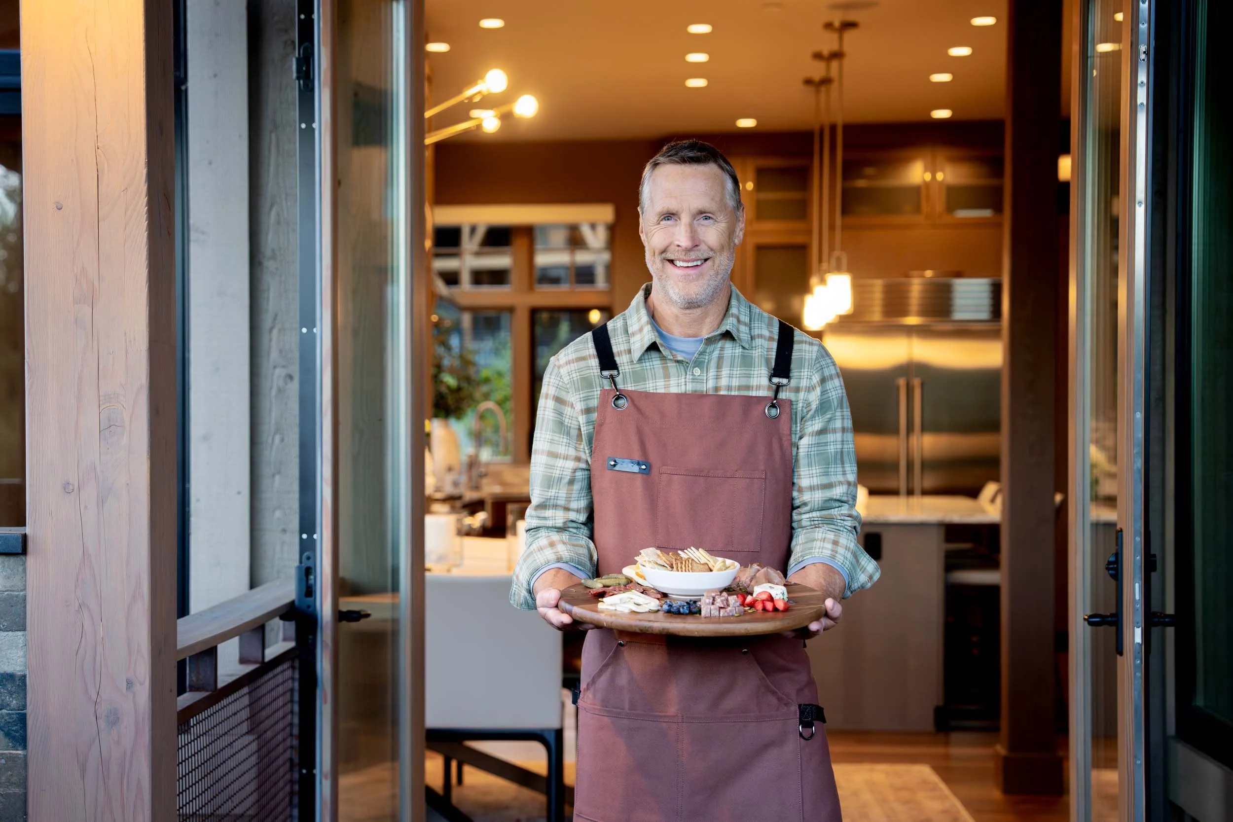 Man-Holding-Appetizers-in-Kitchen-Doorway.jpg