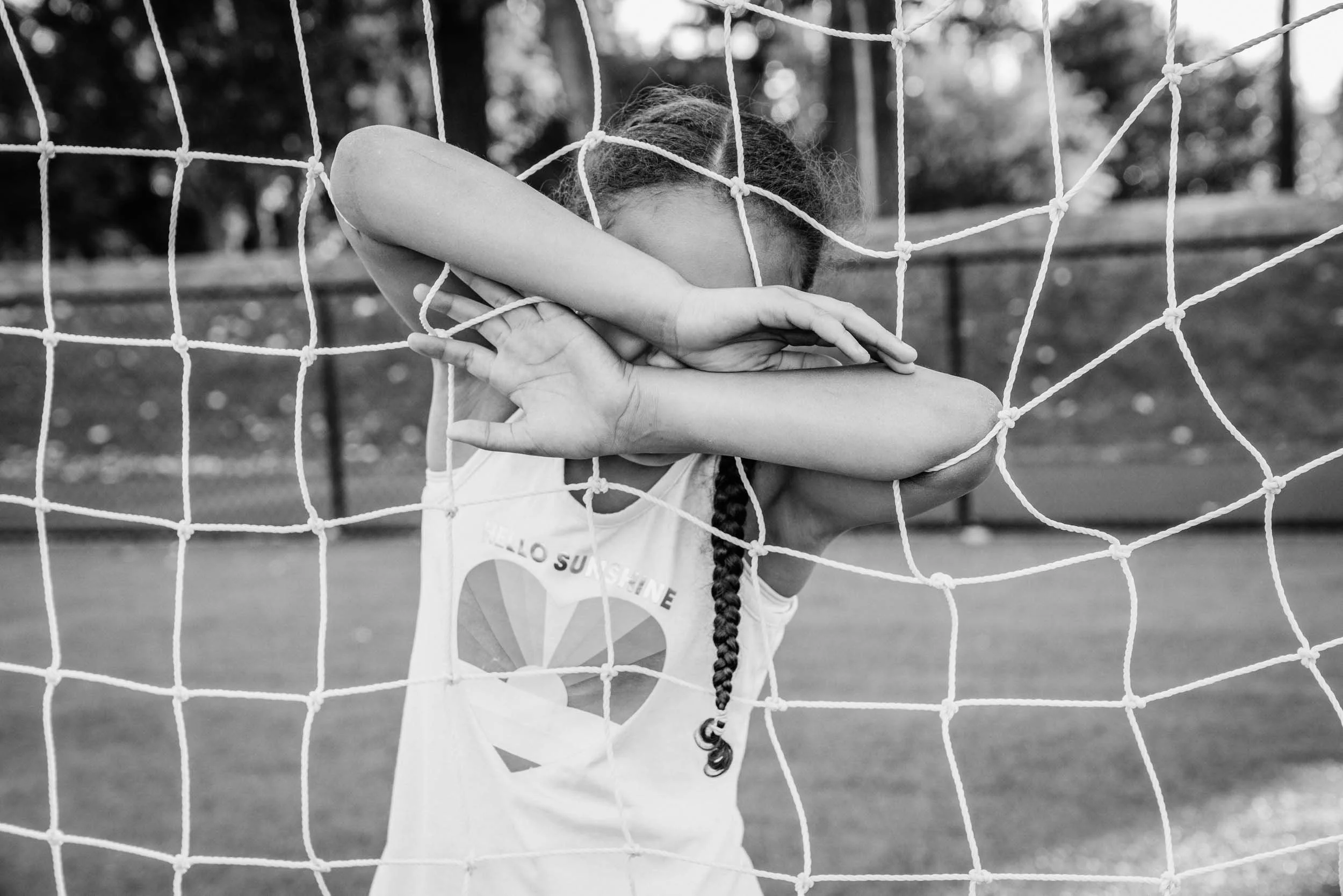 Girl-with-arms-in-net-covering-face.jpg
