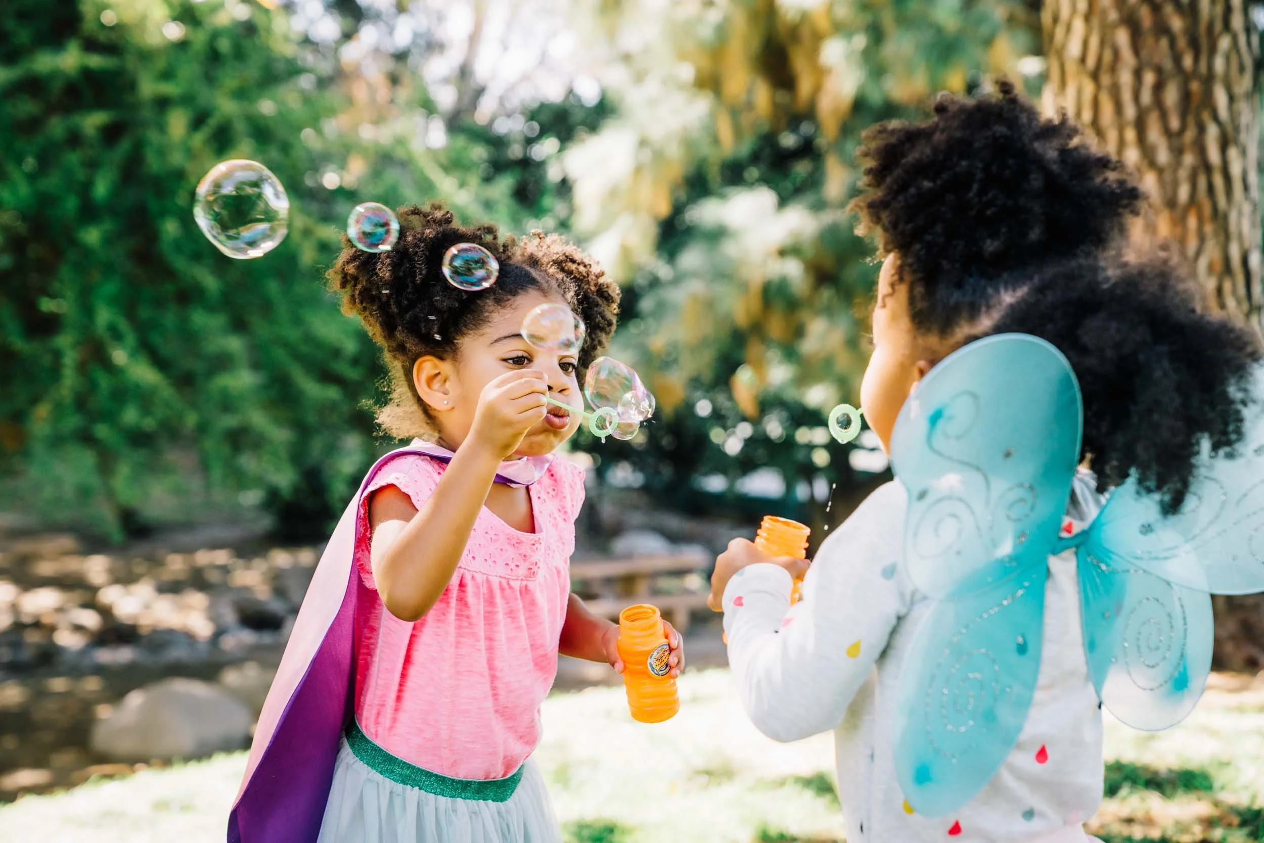 Girls-Blowing-Bubbles-Outdoors.jpg