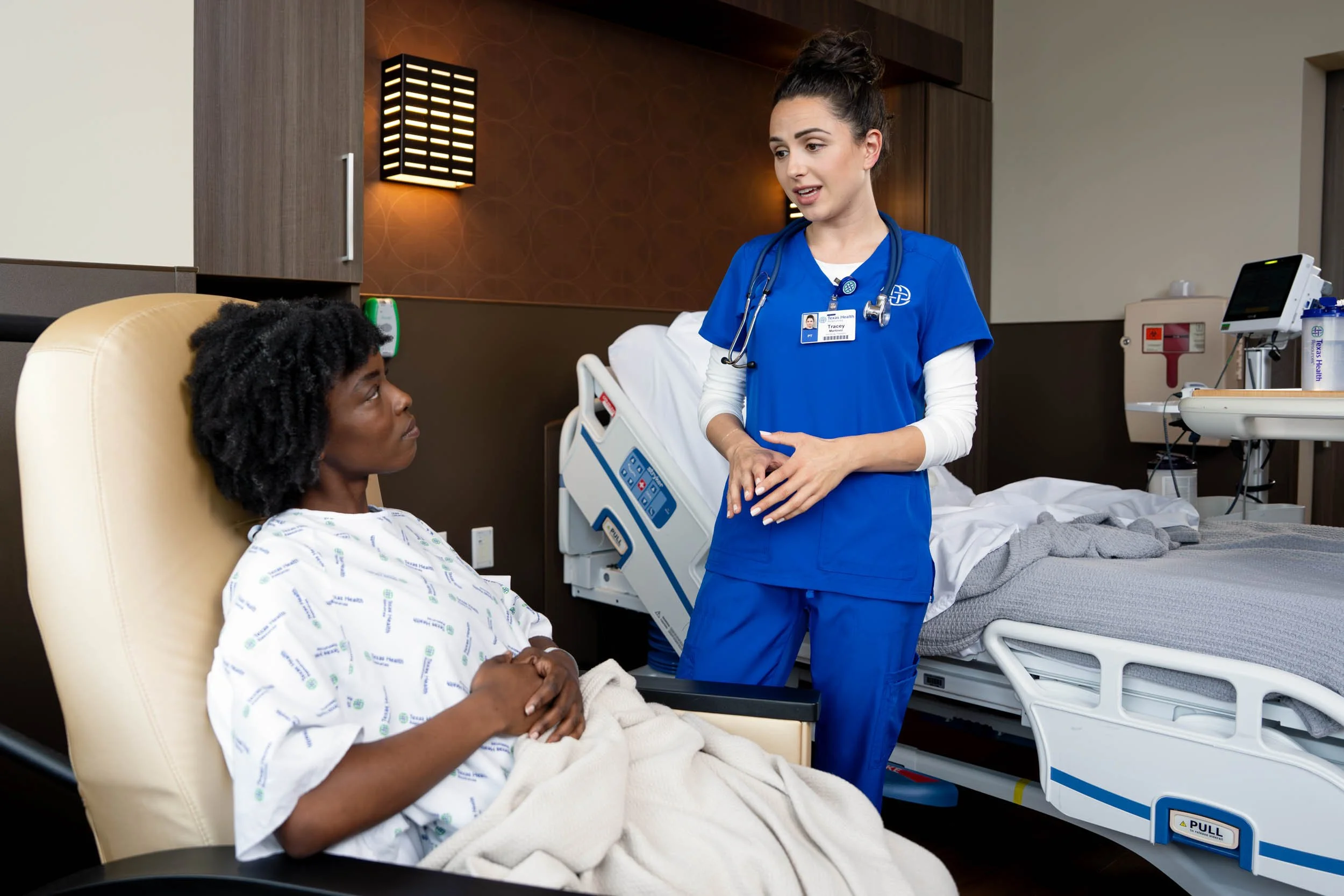 Physical-Therapy-Nurse-Talking-with-Patient-in-Hospital-Room.jpg