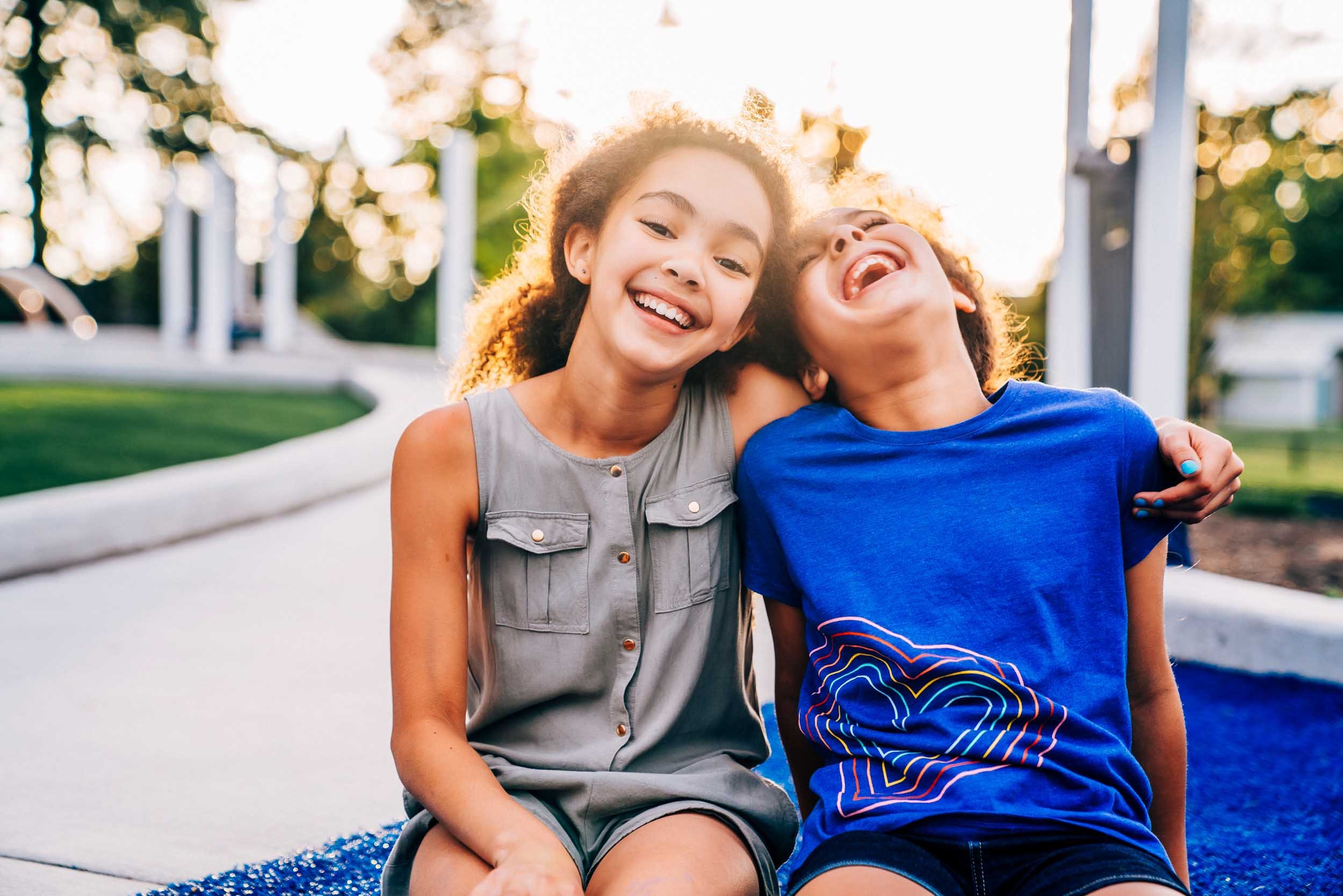 Girls-Hugging-and-Laughing-in-Park.jpg