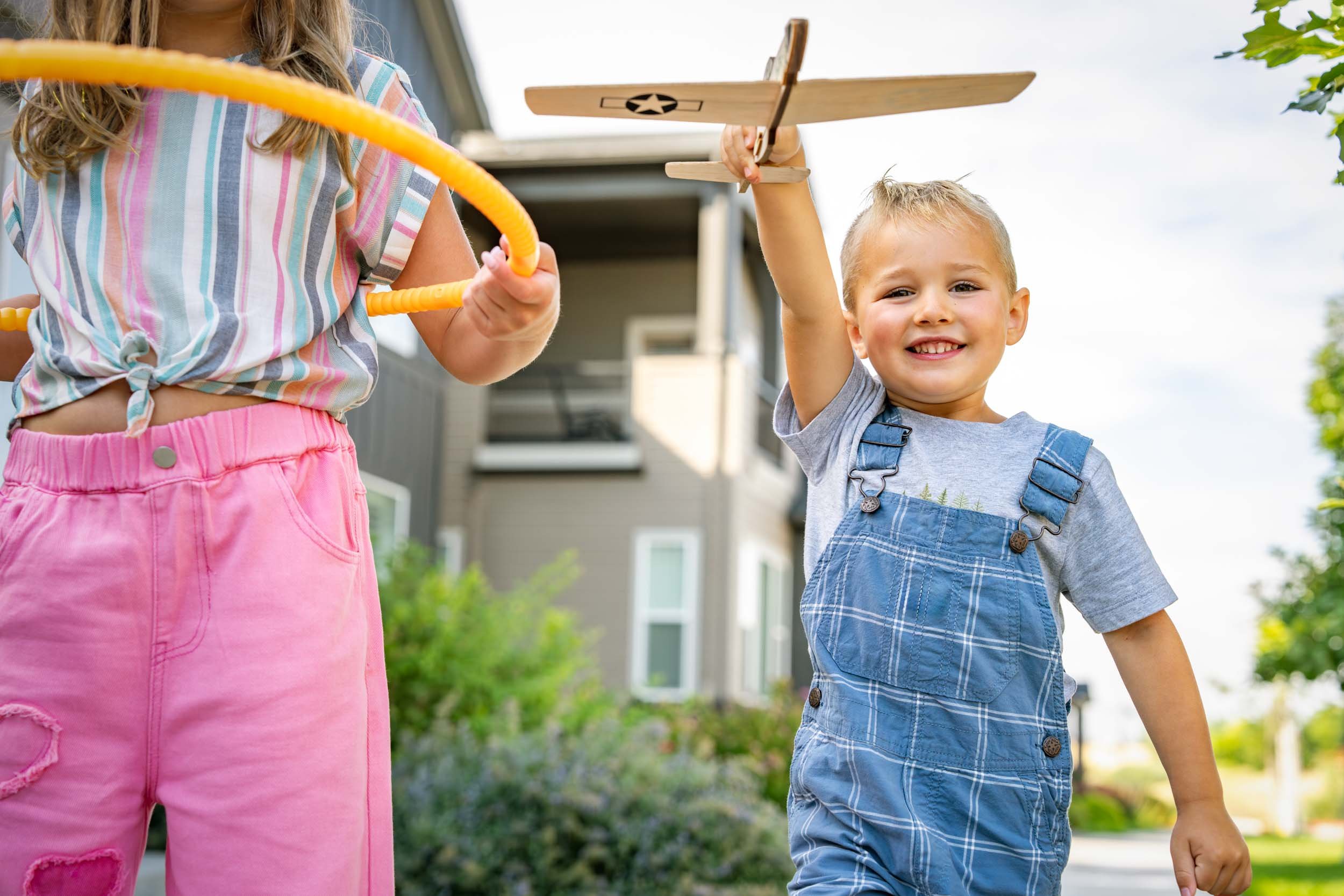Children-Playing-Outdoors-with-Toy-Airplane.jpg