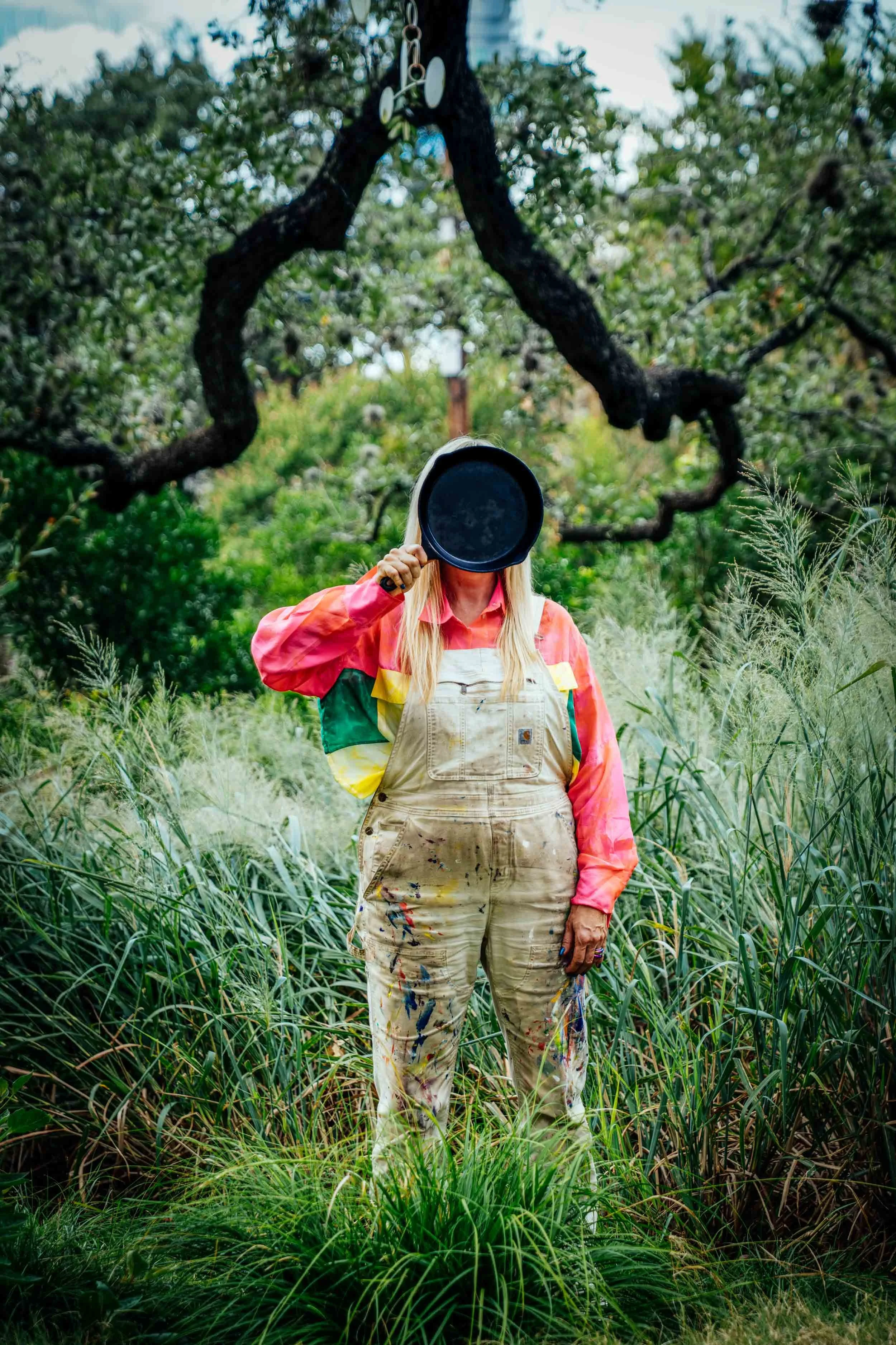 Woman-in-Nature-Holding-Skillet-in-Front-of-Face.jpg