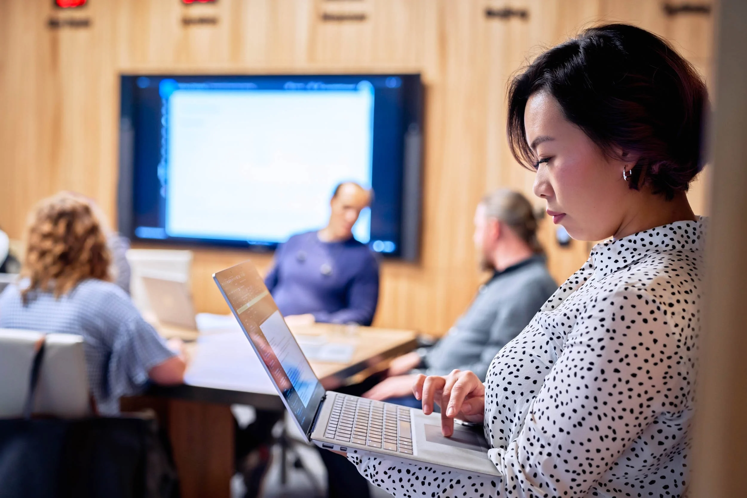 Woman-on-Laptop-in-Conference-Room-Doorway.jpg
