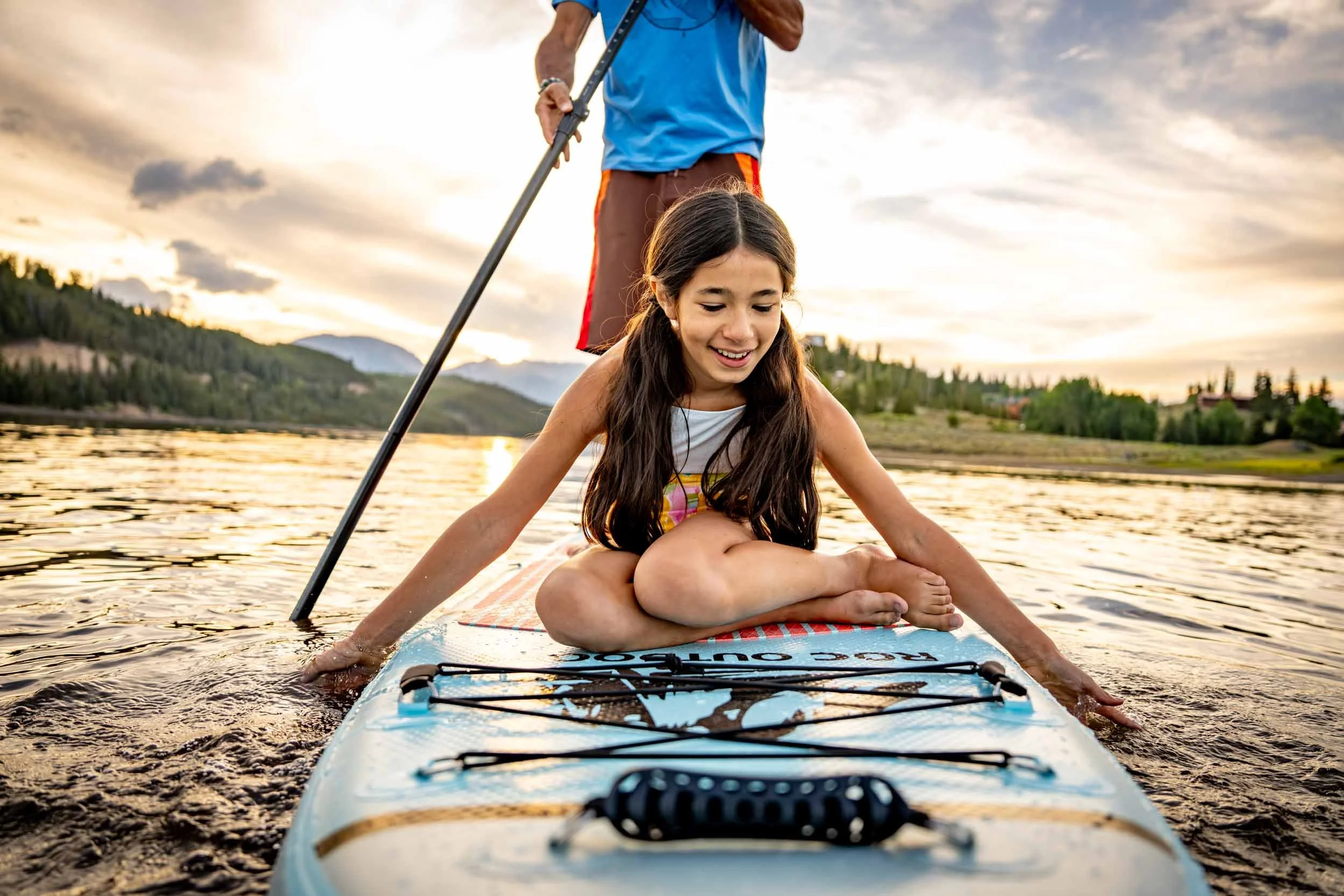 Girl-Riding-on-Dads-Paddle-Board.jpg