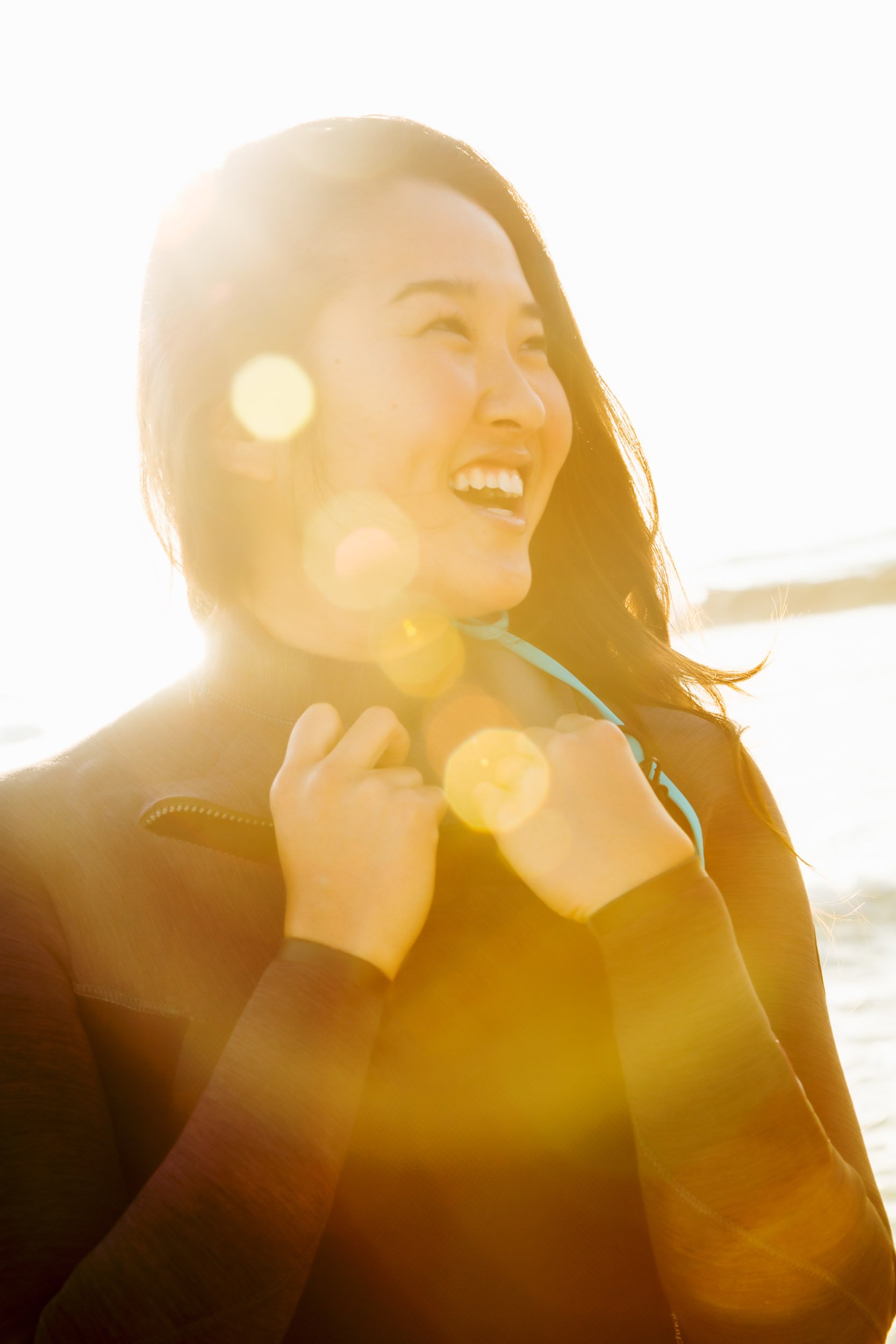 Woman-in-Sun-Flare-Smiling-Seaside.jpg