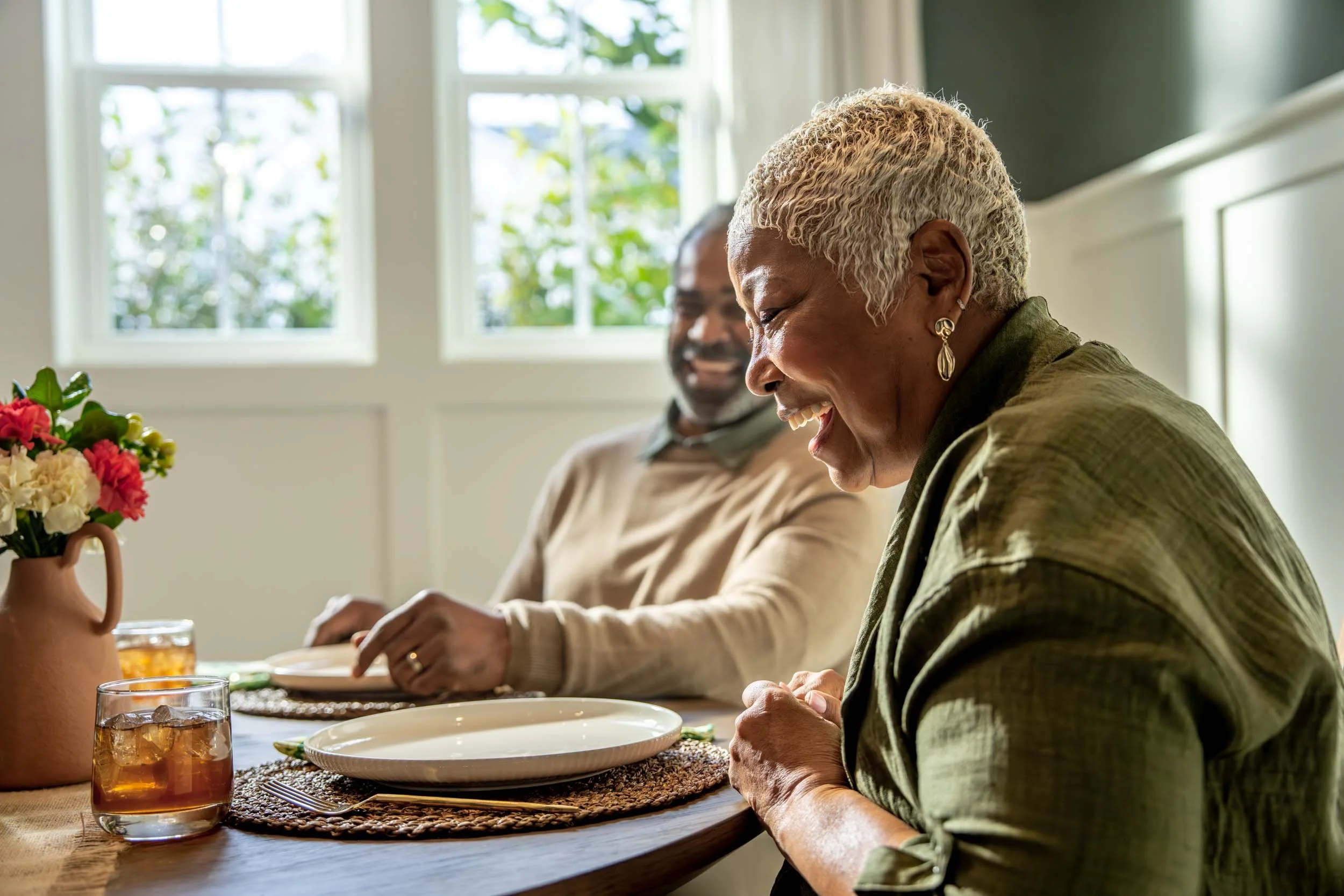 Woman-Laughing-at-Dinner-Table.jpg