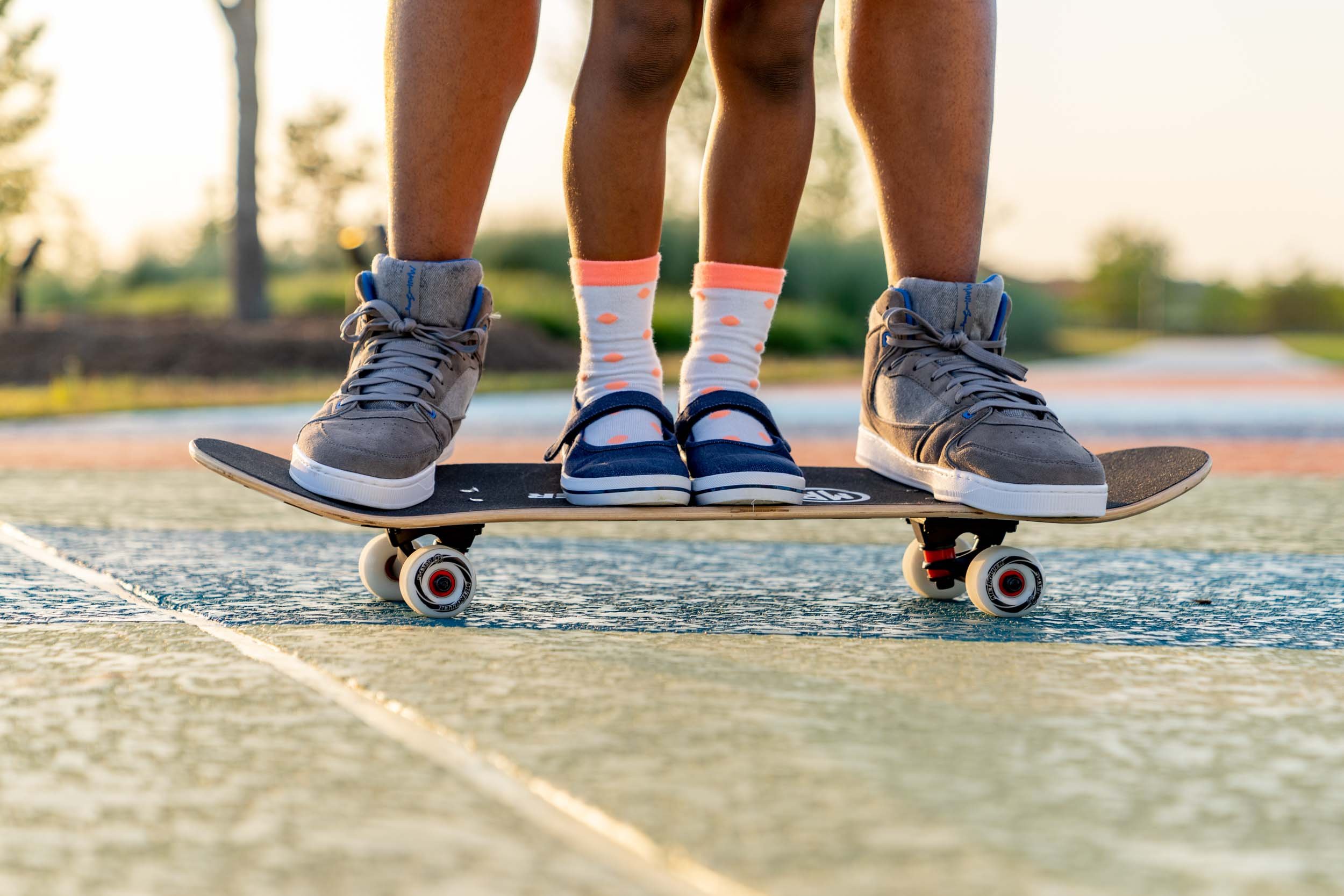 Adult-and-Child-Feet-Standing-on-Skateboard.jpg