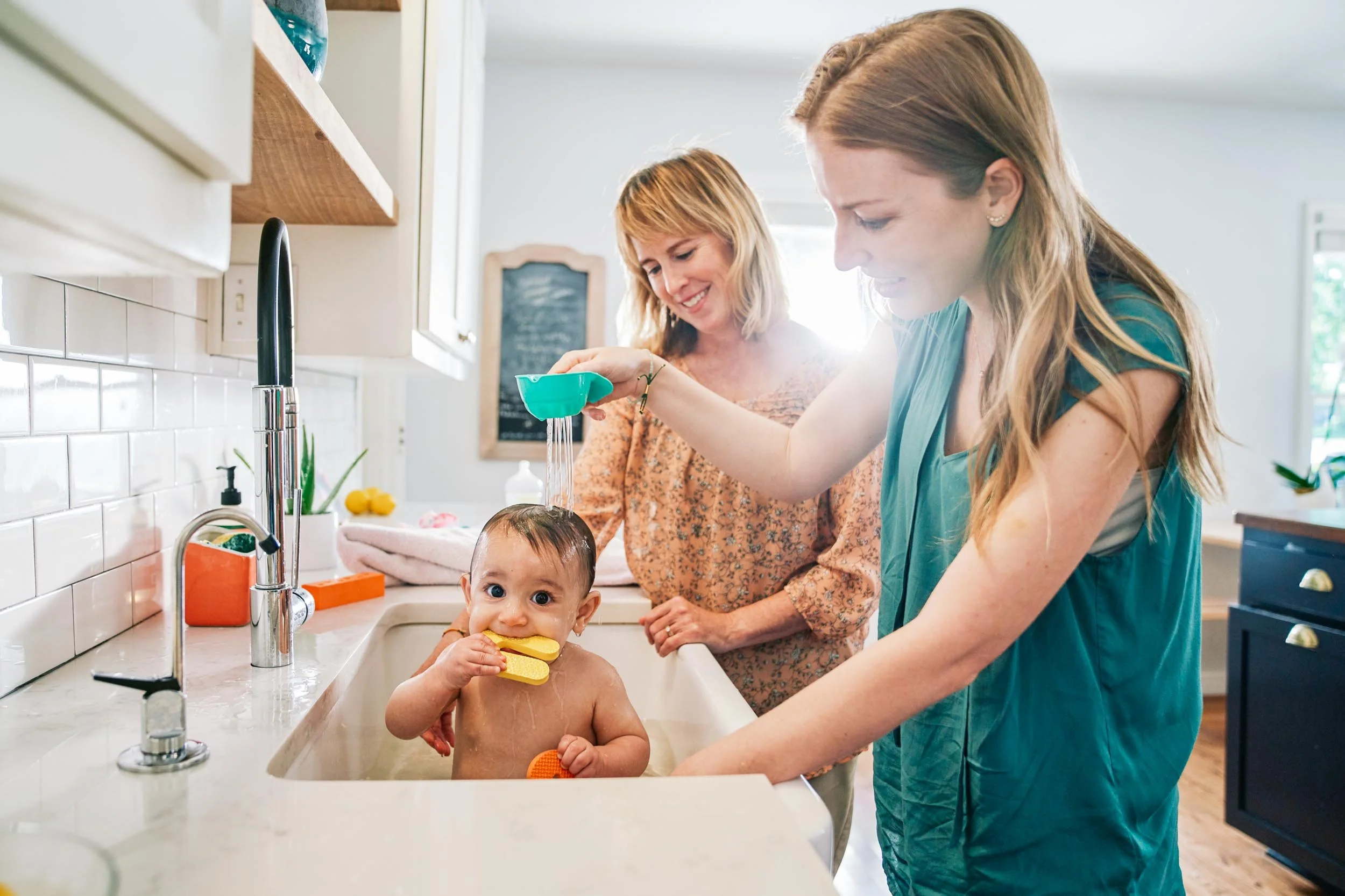 Women-Giving-Baby-Bath-in-Kitchen-Sink.jpg