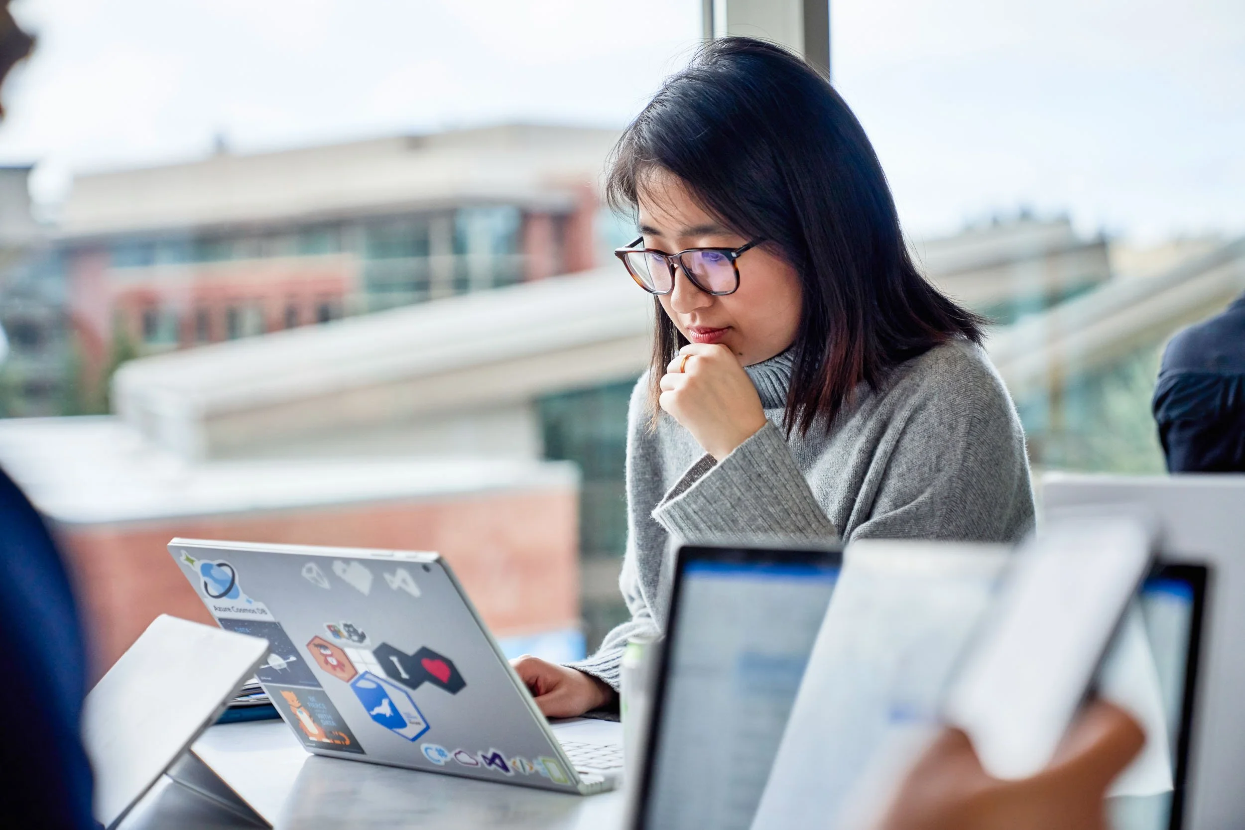 Woman-Working-on-Laptop-in-Meeting.jpg