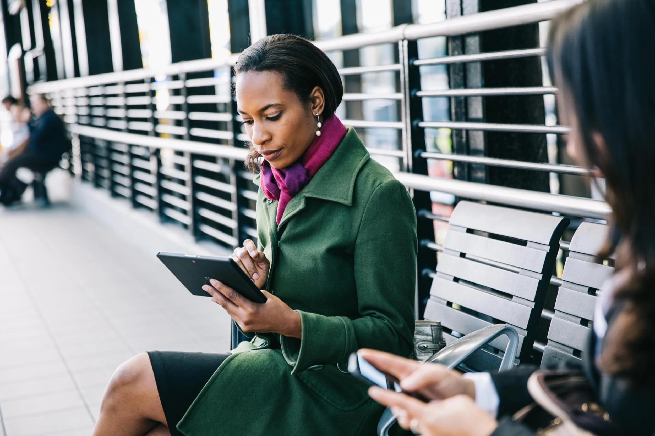 Woman-Using-Tablet-in-Transit-Station.jpg