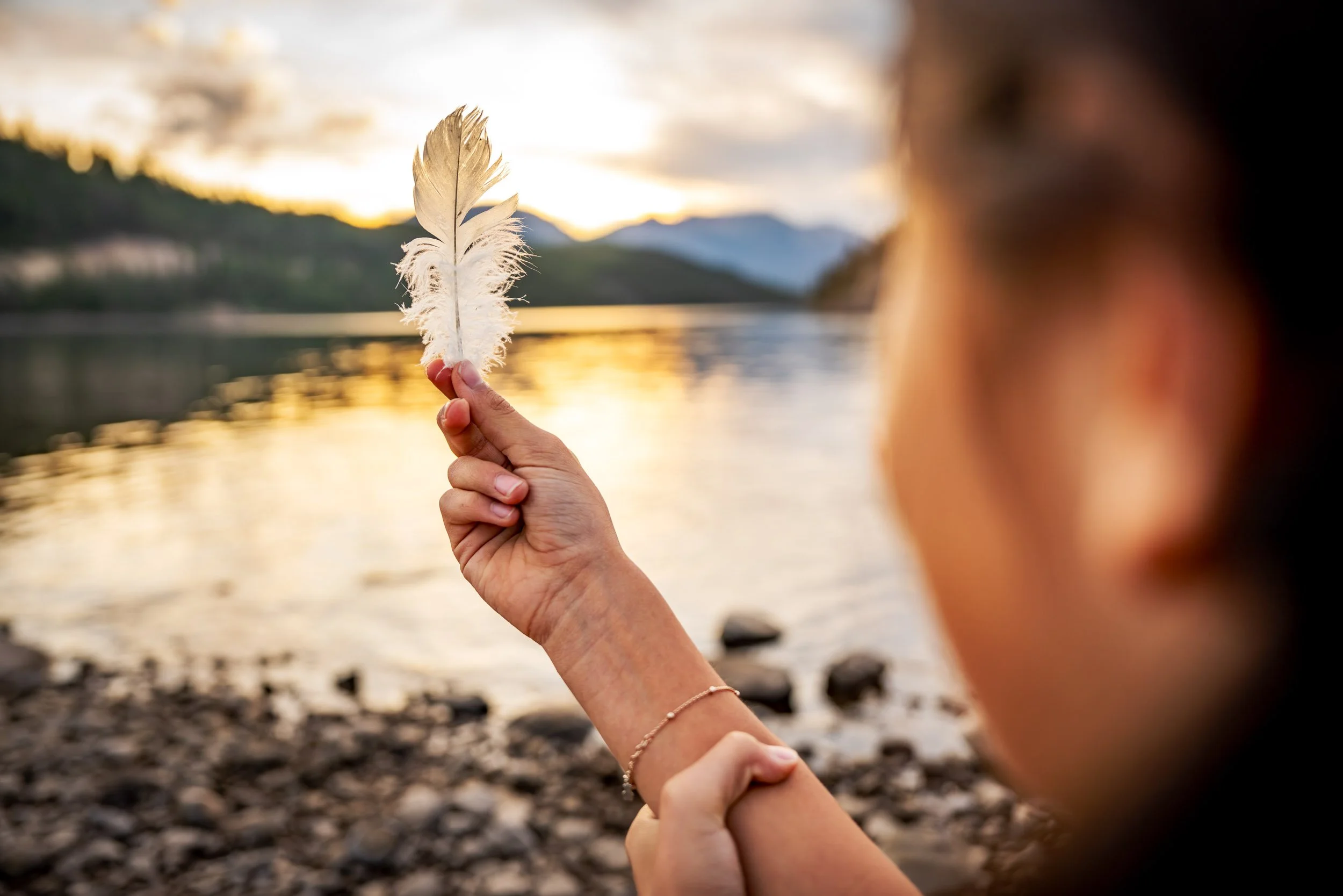 Girl-Holding-Feather-by-the-Lake.jpg