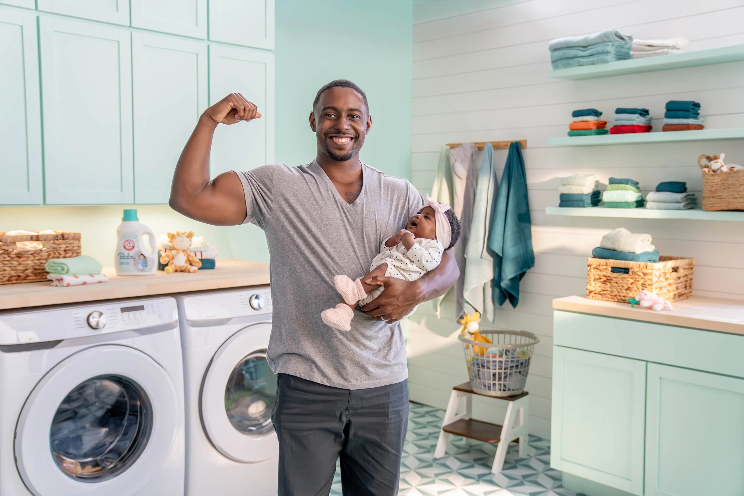 Man-Holding-Baby-in-Laundry-Room.jpg