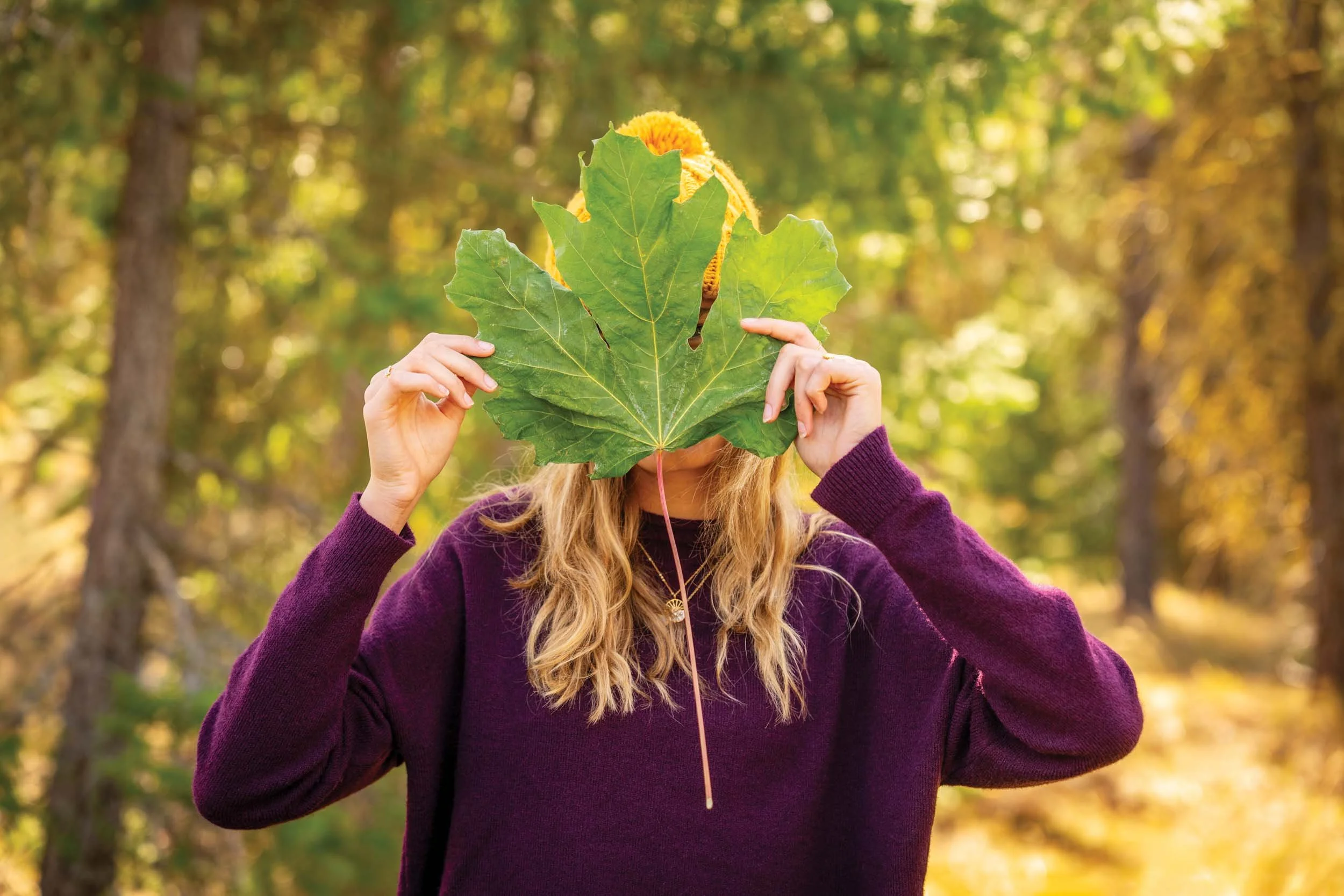 Girl-Holding-Leaf-in-Front-of-Face.jpg