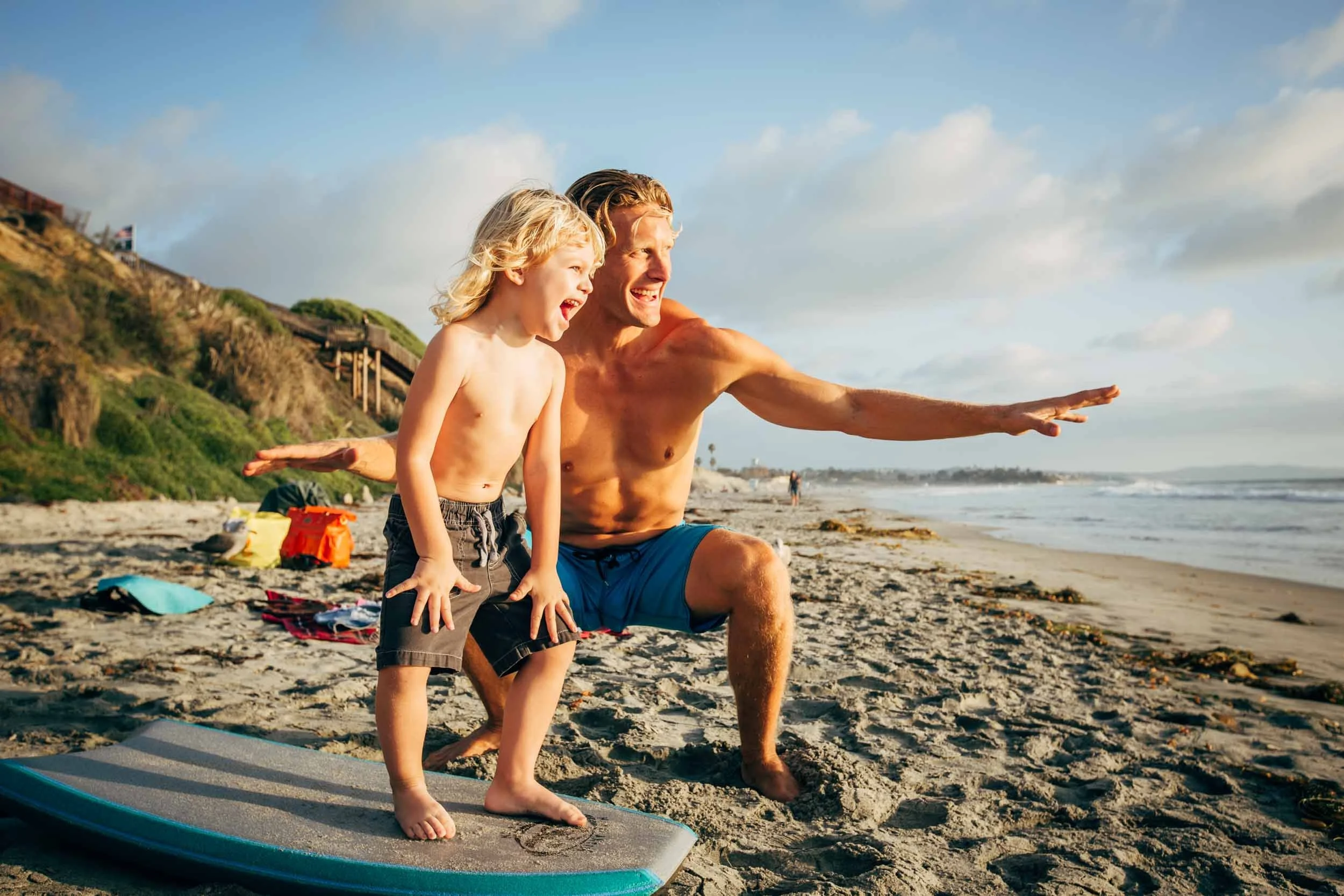 Man-teaching-boy-to-surf.jpg