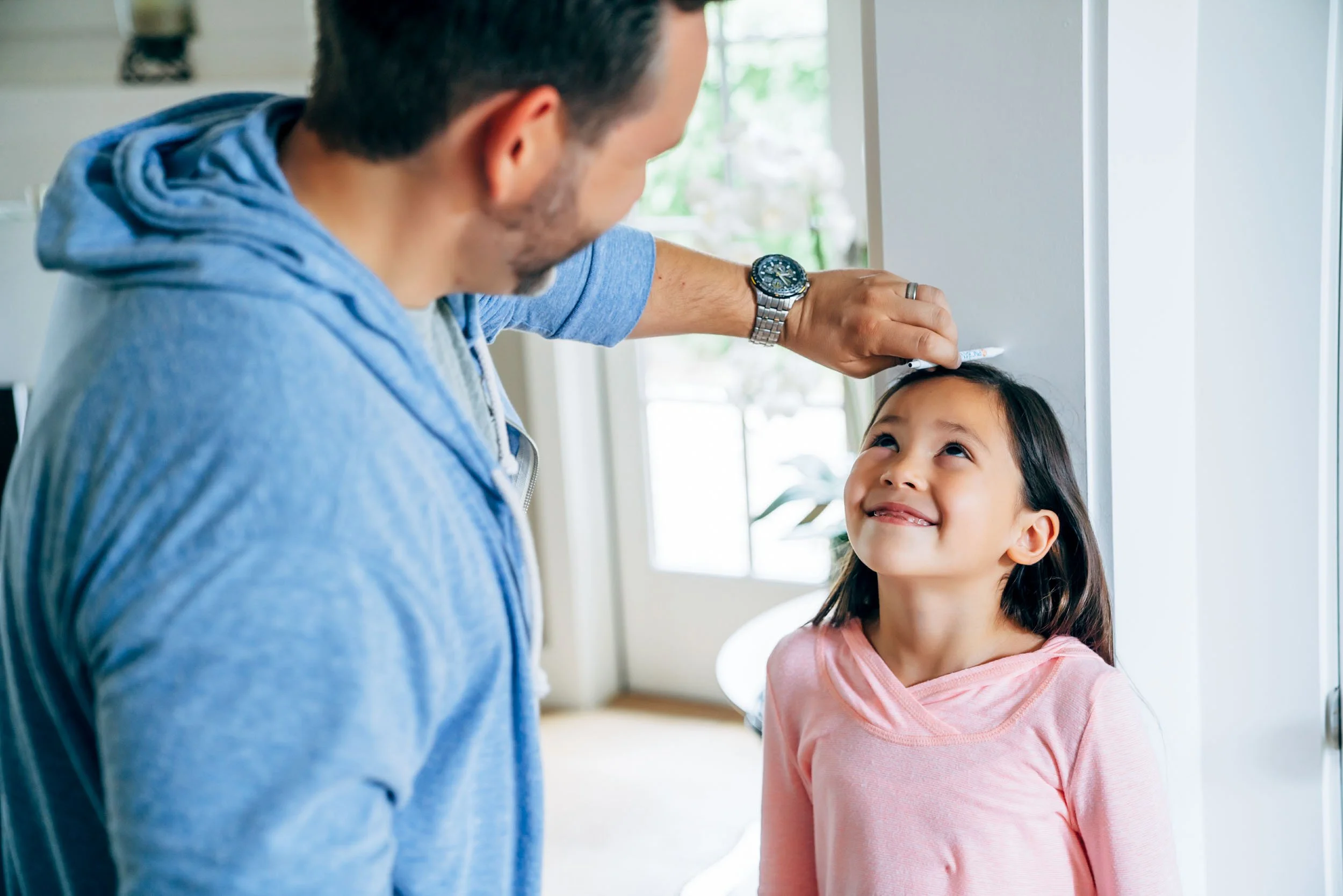 Dad-Measuring-Girls-Height-on-Wall.jpg