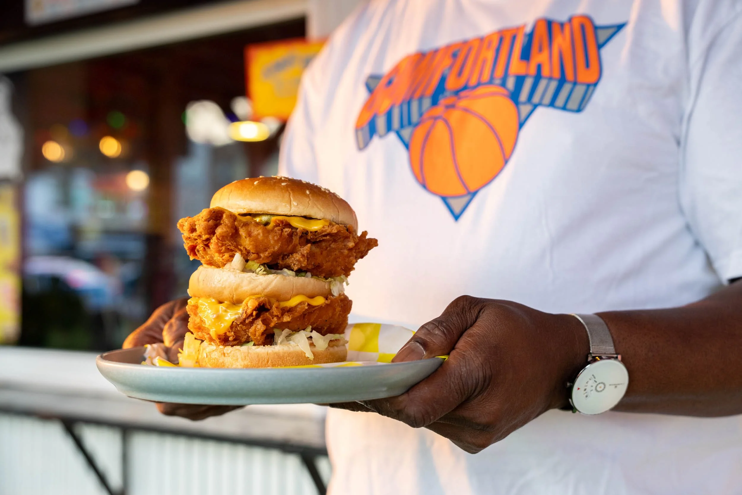 Man-Holding-Comfortland-Fried-Chicken-Sandwich-Close-up.jpg