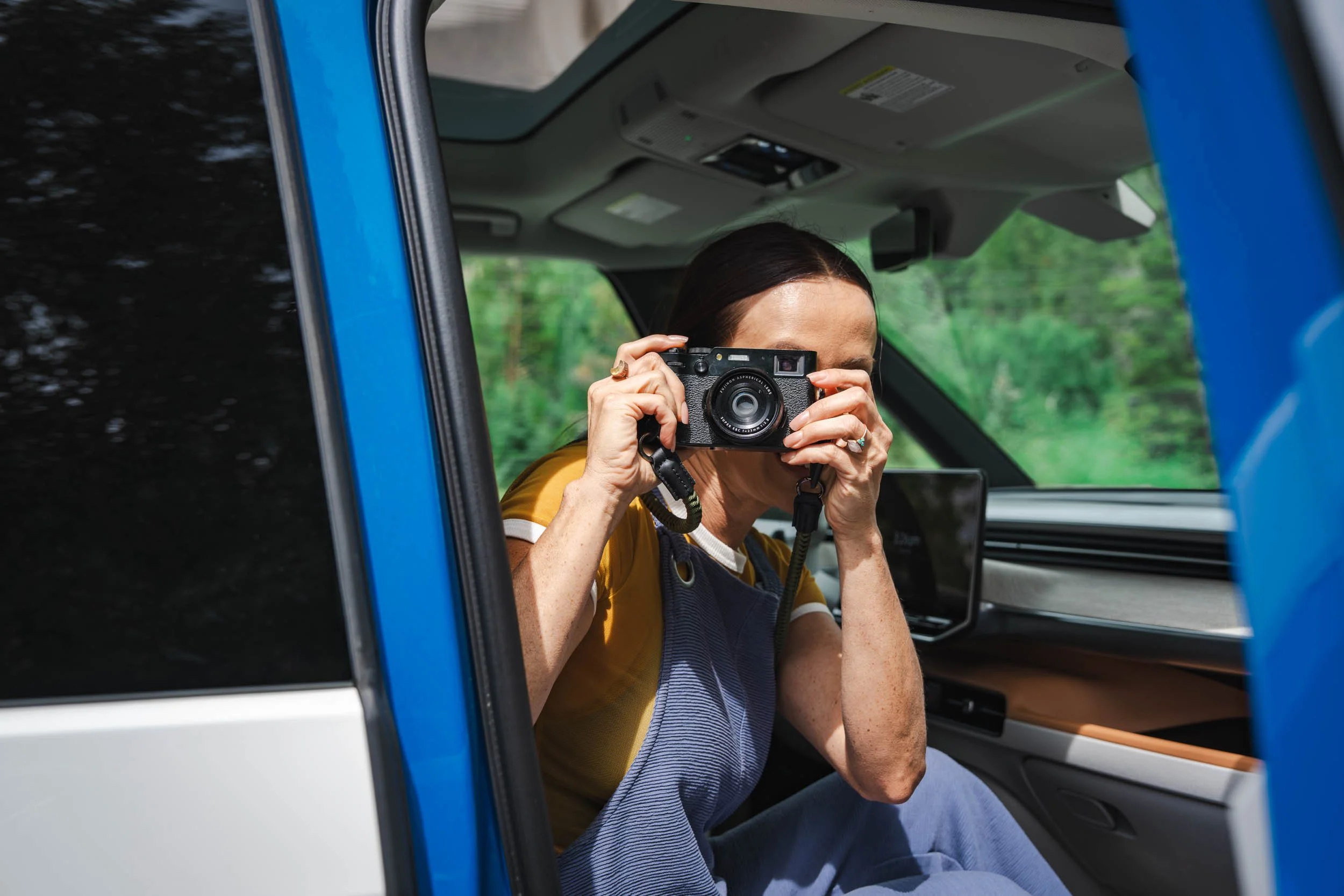 Woman-Photographing-From-Front-Seat-of-Car.jpg