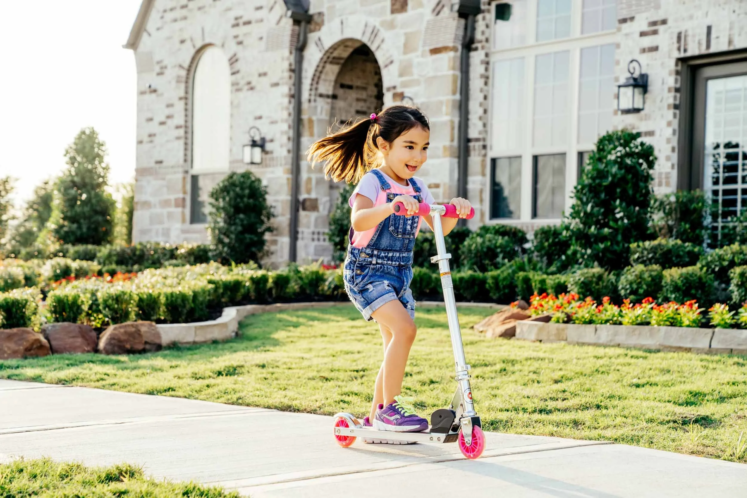 Child-Riding-Scooter-Outside-House.jpg