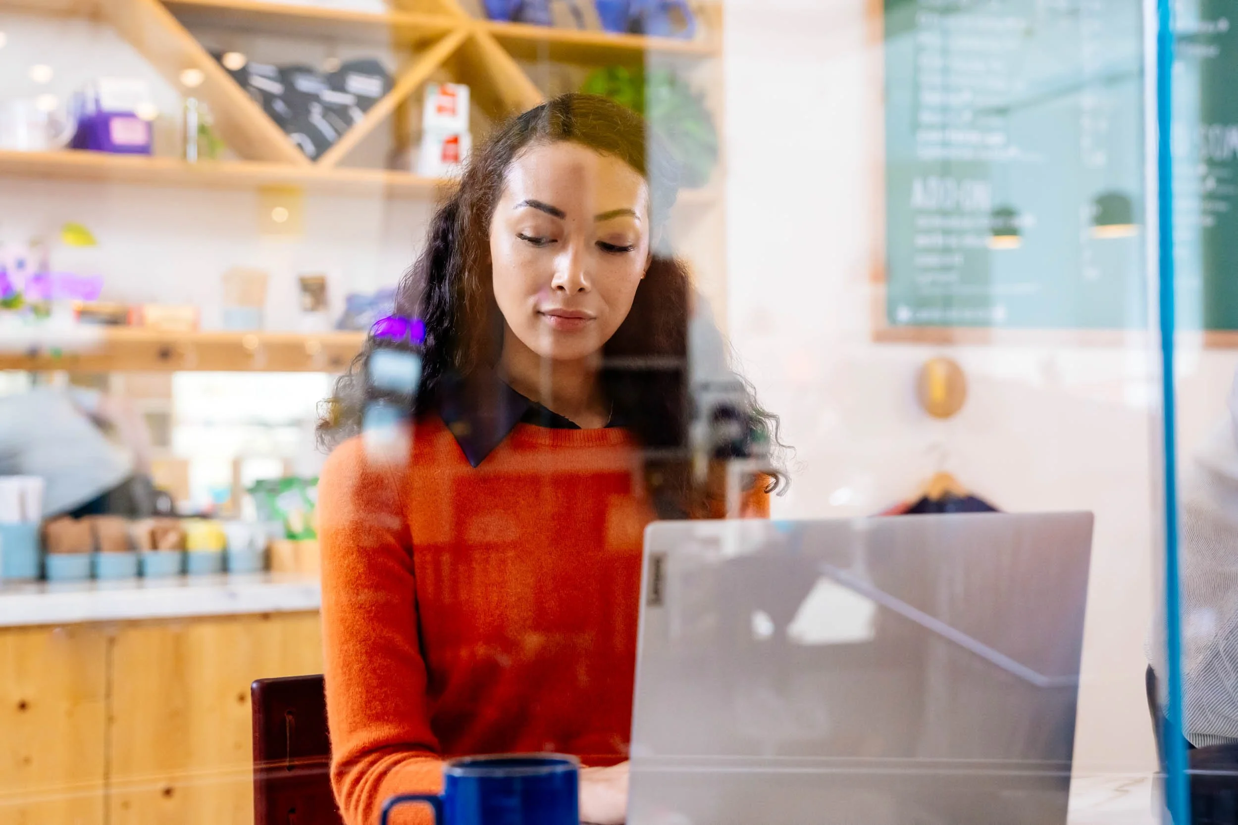 Woman-Working-on-Laptop-in-Coffee-Shop.jpg