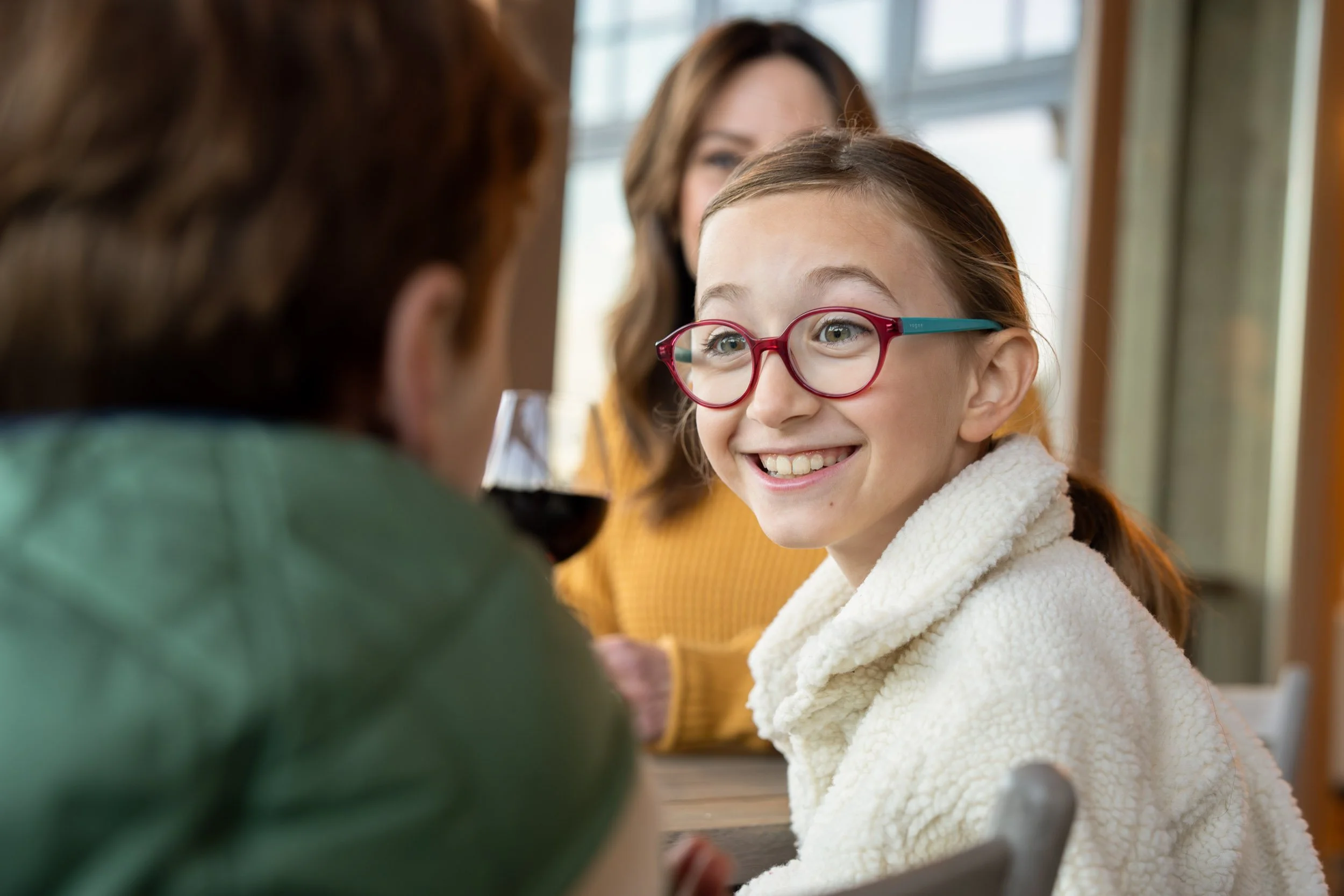 Girl-Smiling-Across-Table.jpg