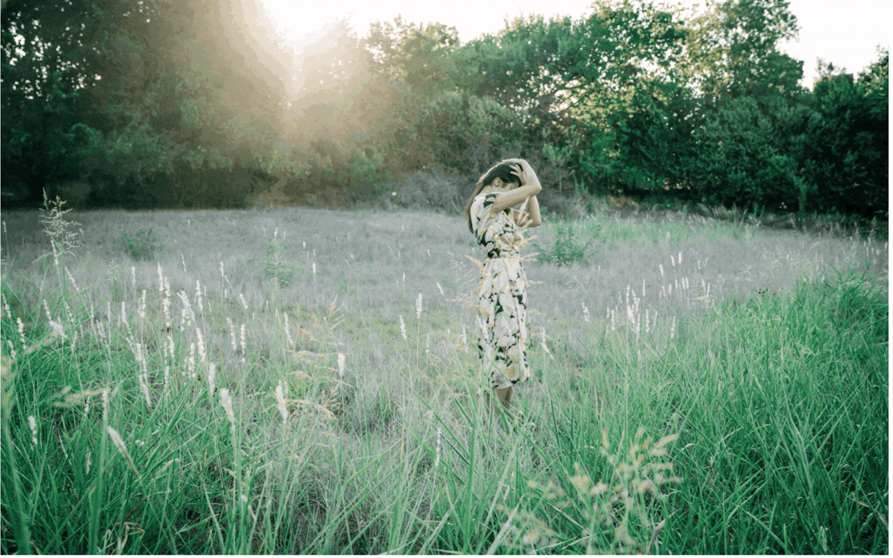 woman-in-floral-dress-dancing-in-grass-field.gif