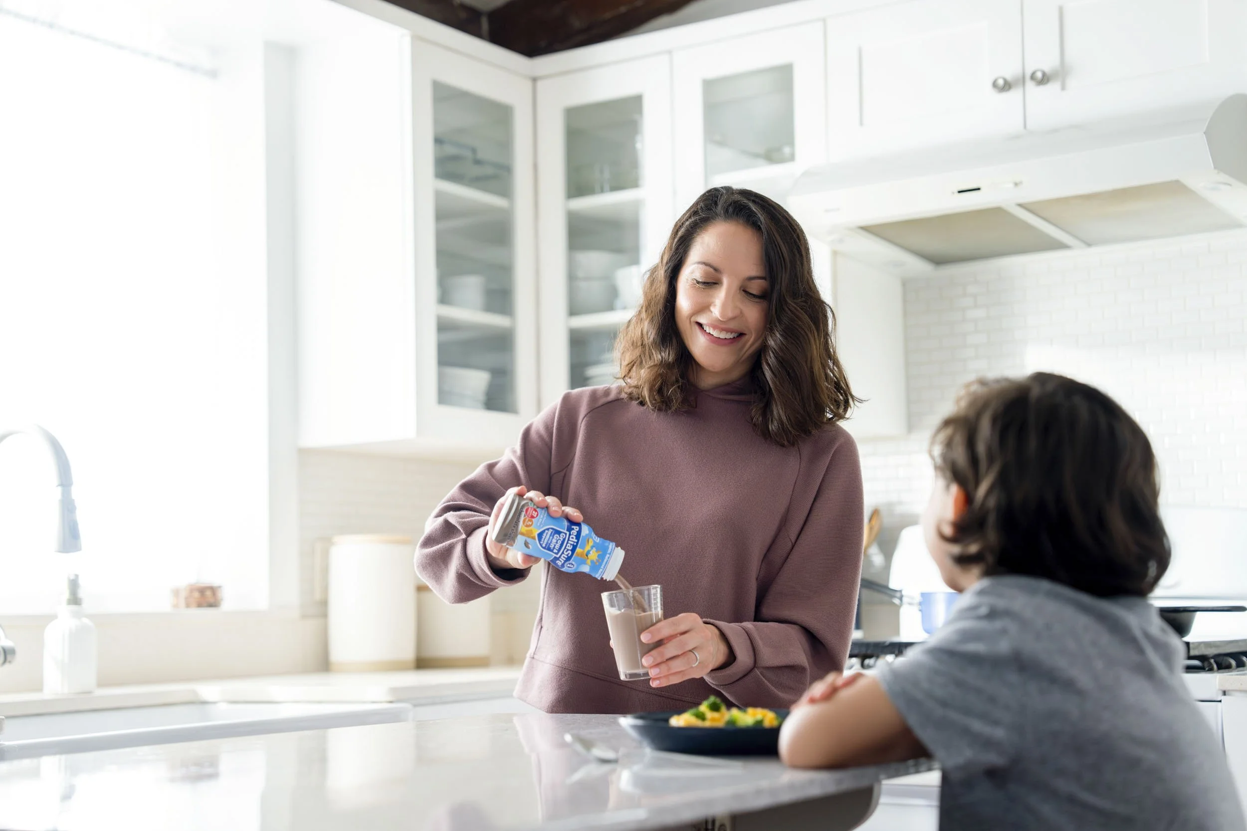 Woman-Pouring-Chocolate-Milk-in-Kitchen.JPG