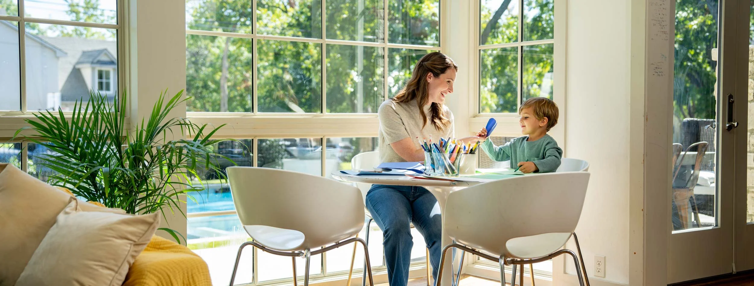 Woman-and-Child-Crafting-by-Sunlit-Window.jpg