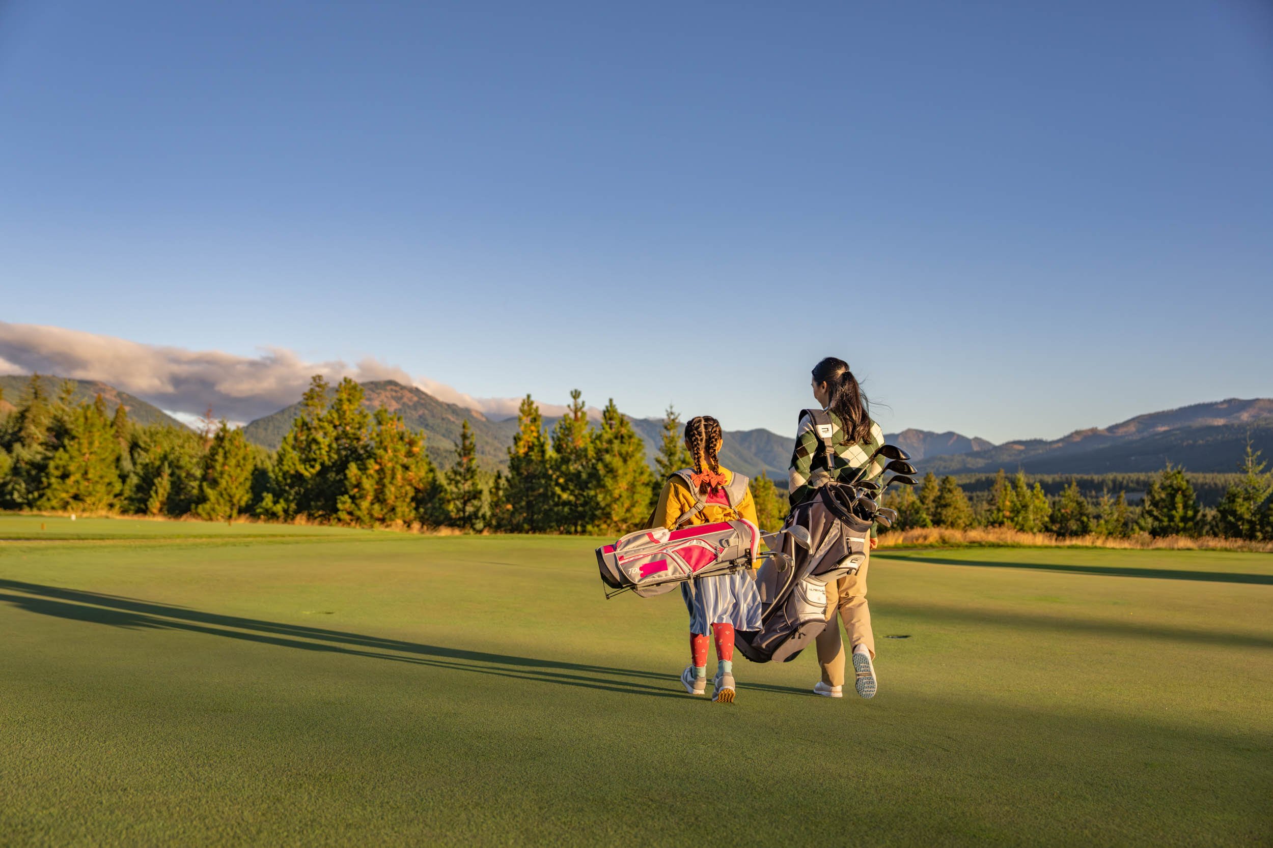 Womand-and-Girl-Golfing-with-Mountain-View.jpg