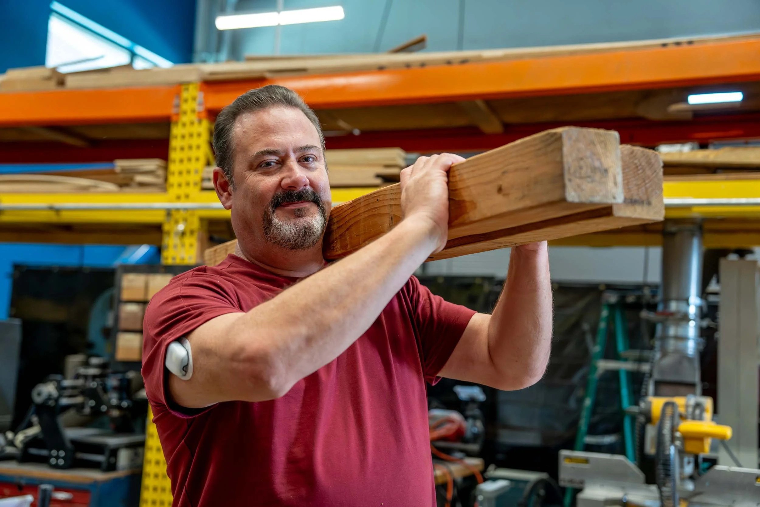 Man-Holding-Wooden-Beam-in-Wood-Shop.jpg