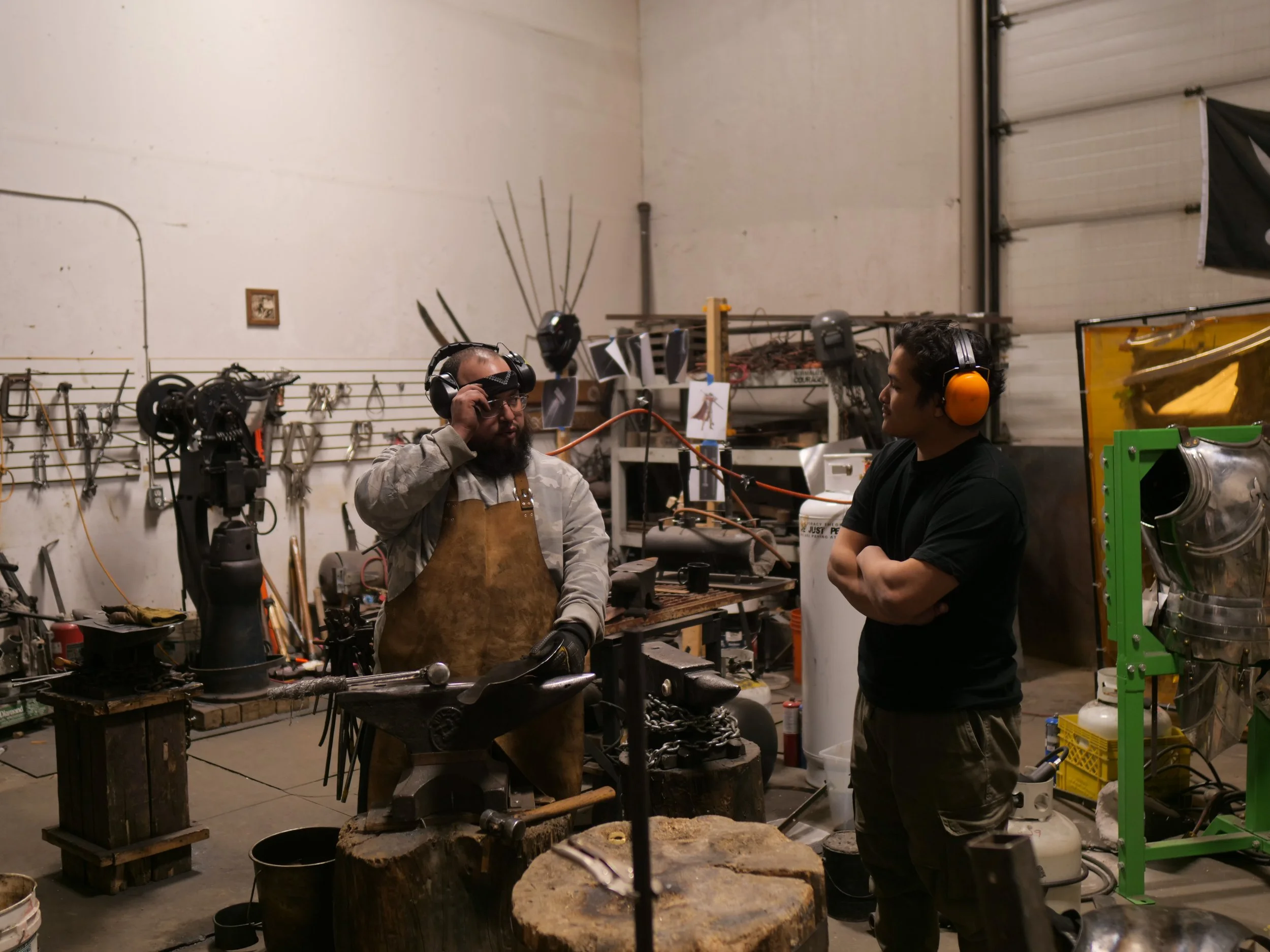 Christian (TLR Staff) learning about the operations of Mount Crom Armouries Workshop with Gonzo.