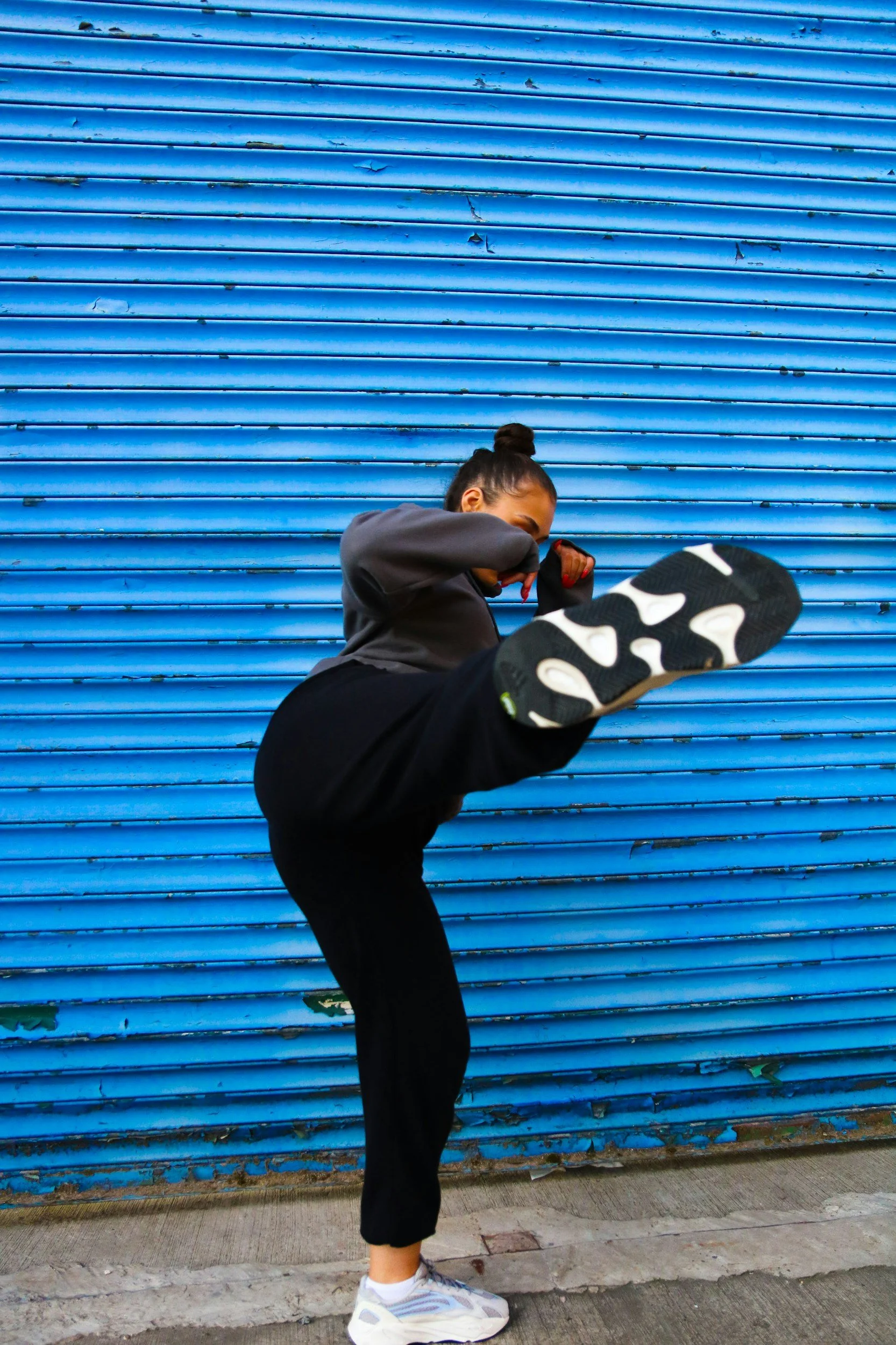Woman practicing martial arts and kicking